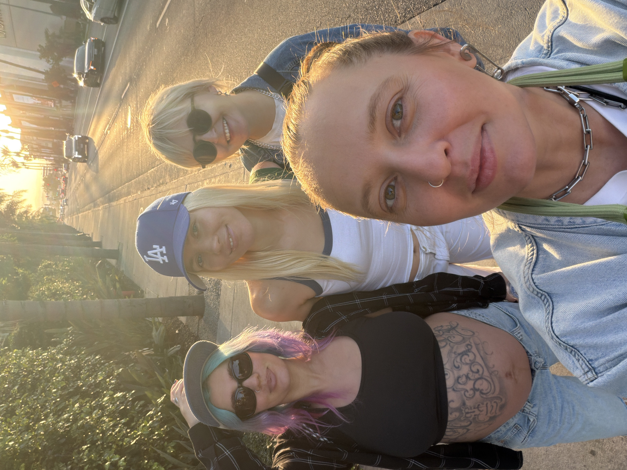 Four women photographed together on Los Angeles street