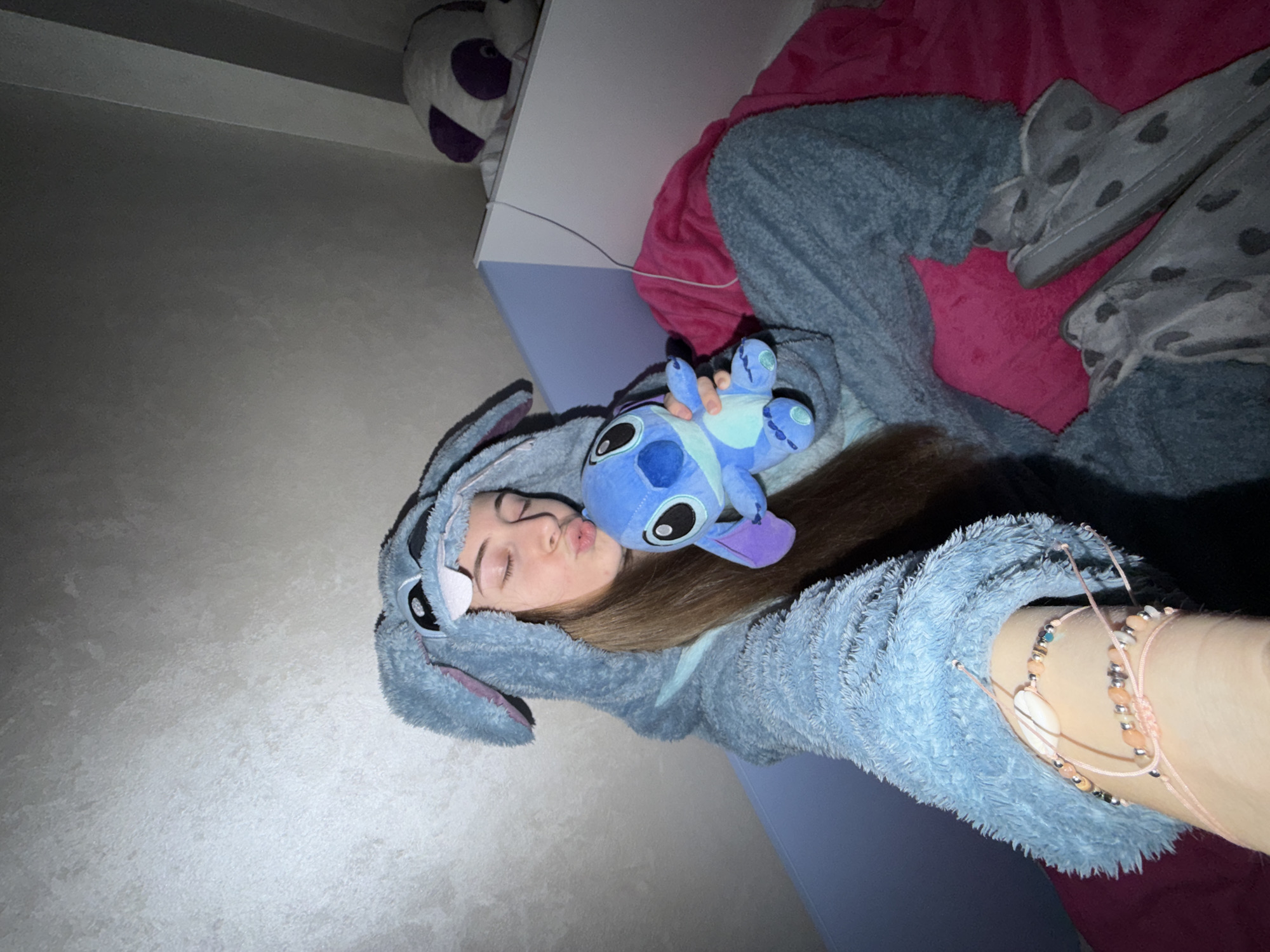 Person in Stitch onesie photographed with plush toy in Plovdiv bedroom