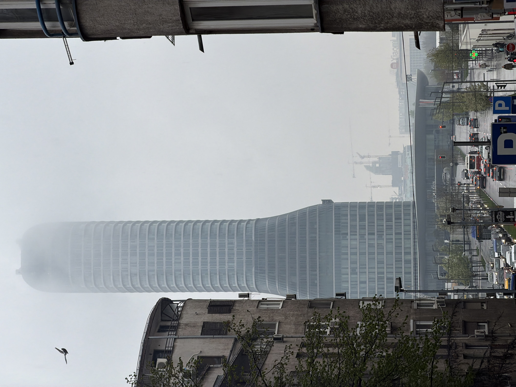 Foggy conditions obscure Belgrade skyline, modern tower visible