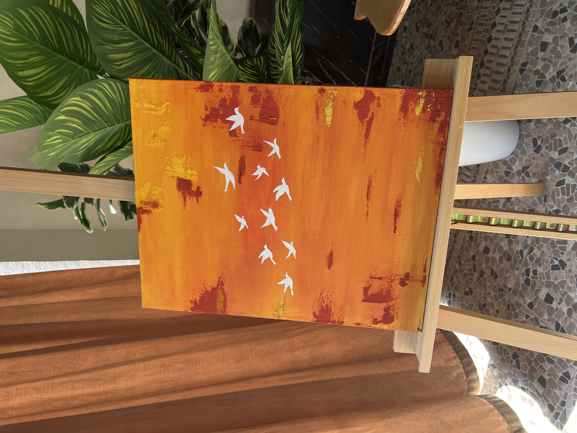 Abstract bird painting and art supplies in a Namangan studio