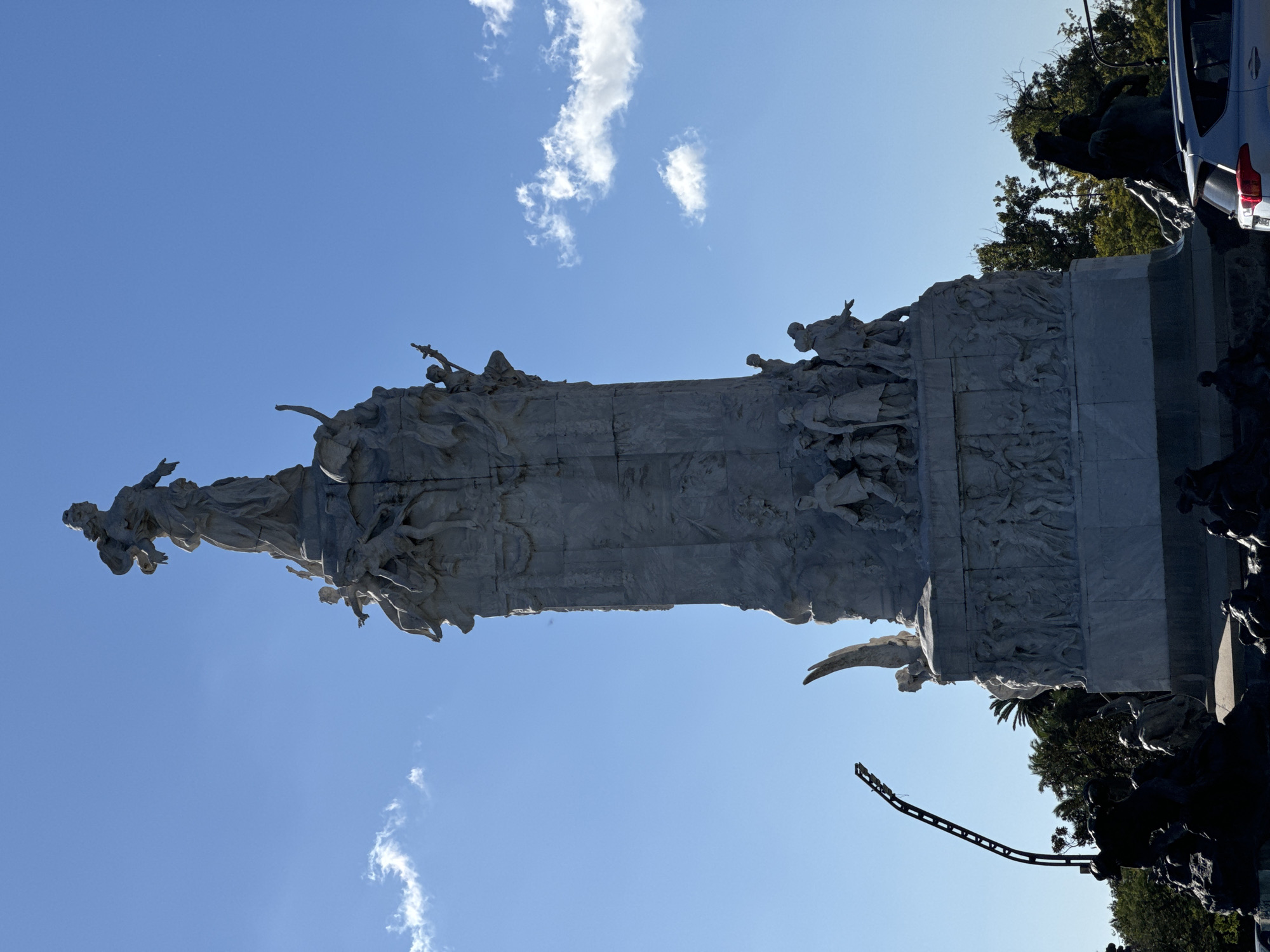 Busy street life documented around ornate Buenos Aires monument
