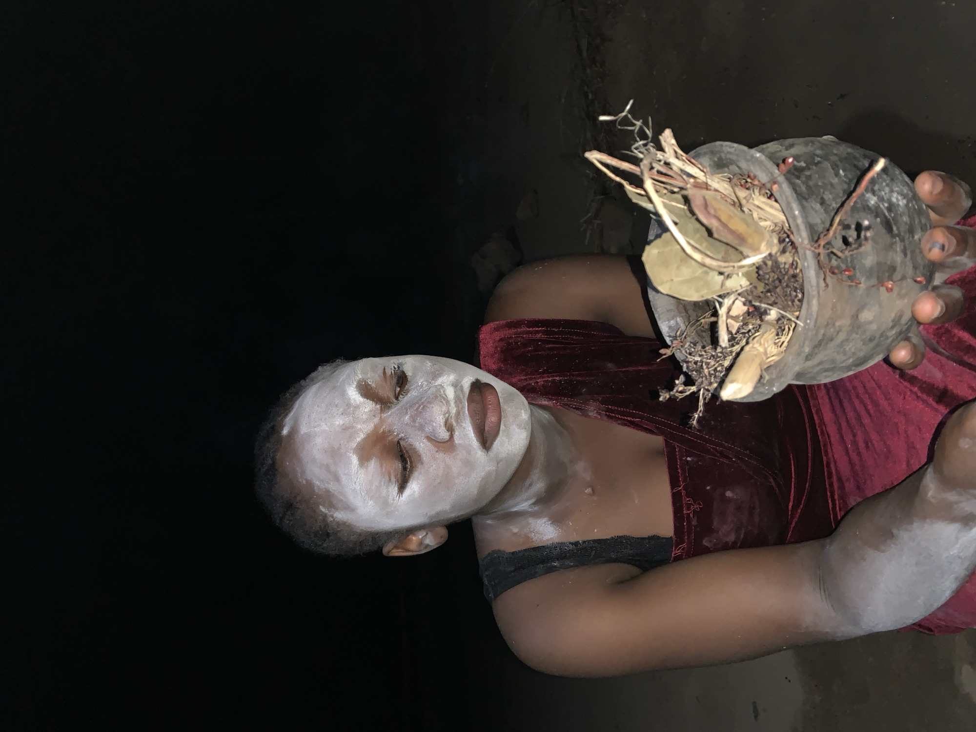 Traditional healer holds plant materials in Nigerian village