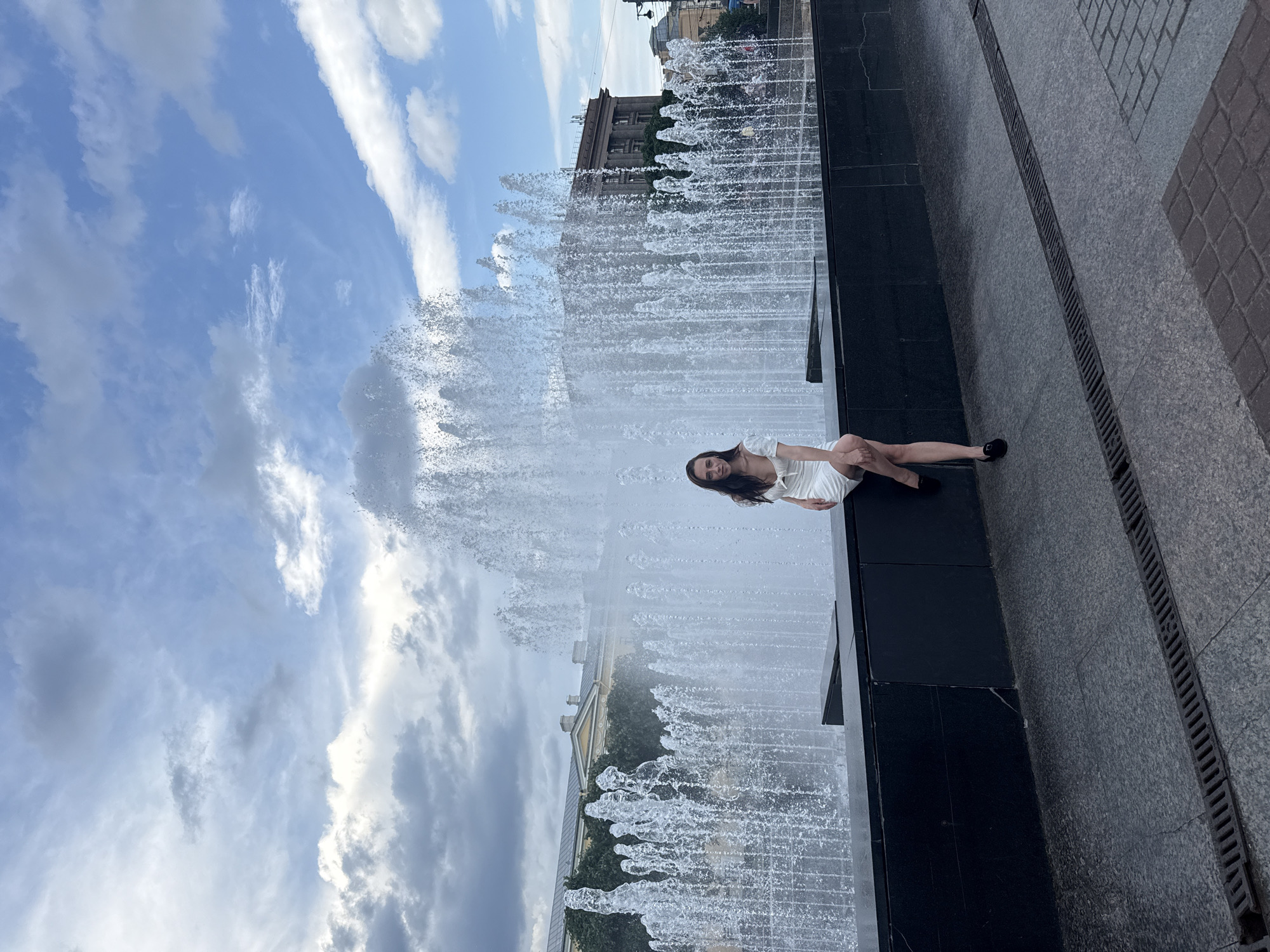 Woman poses for photos at Lenin statue fountain in Saint Petersburg