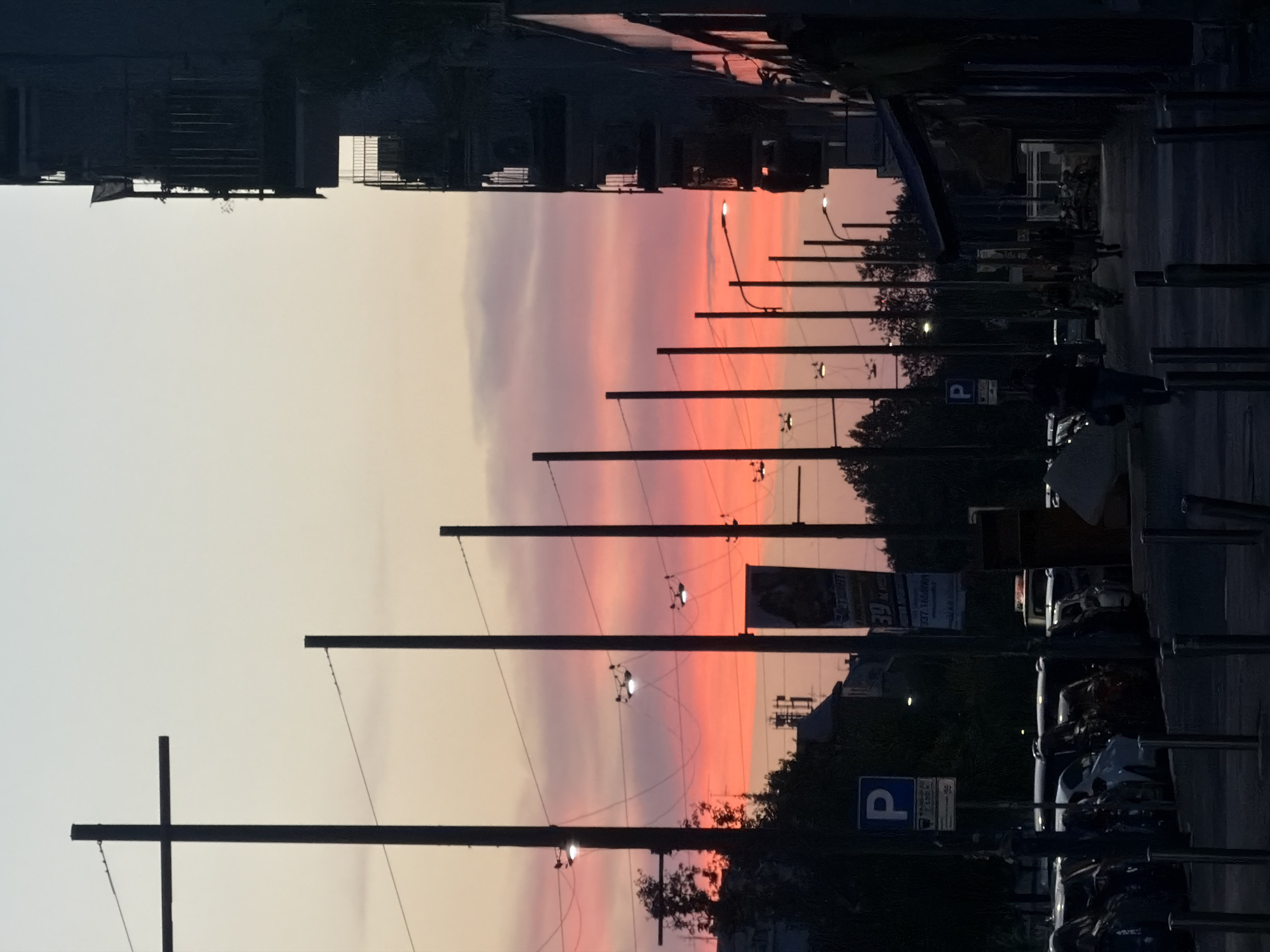 Milan sunset scene with crescent moon and vertical light column