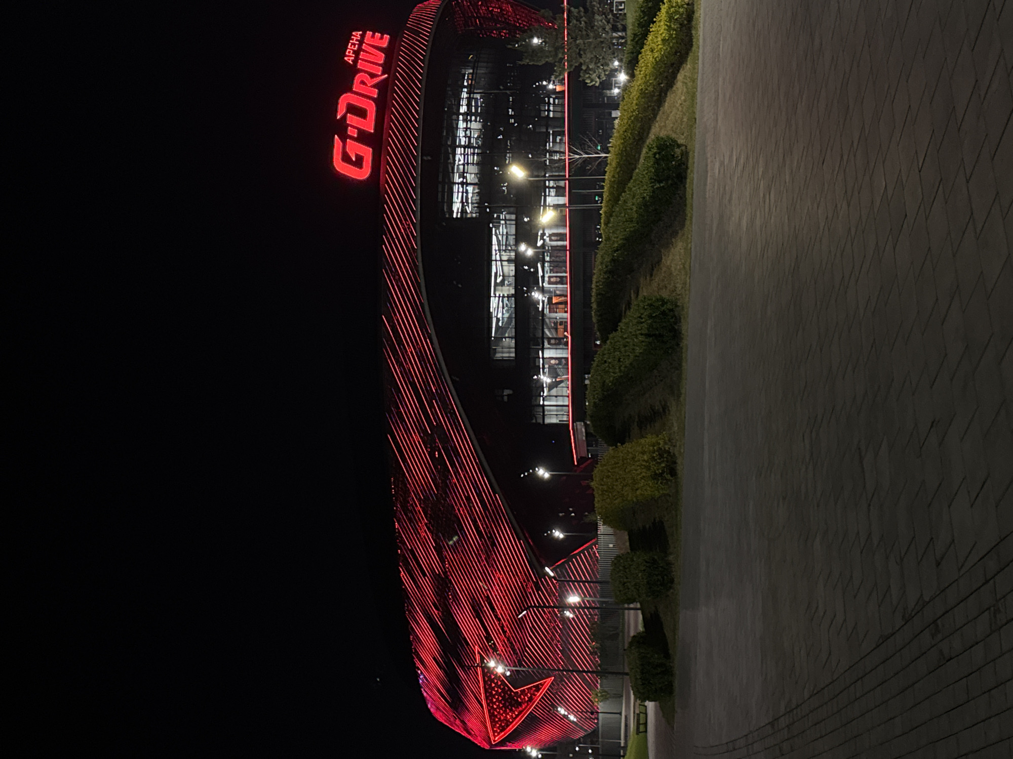 G-Drive Arena illuminated in red neon lights at night