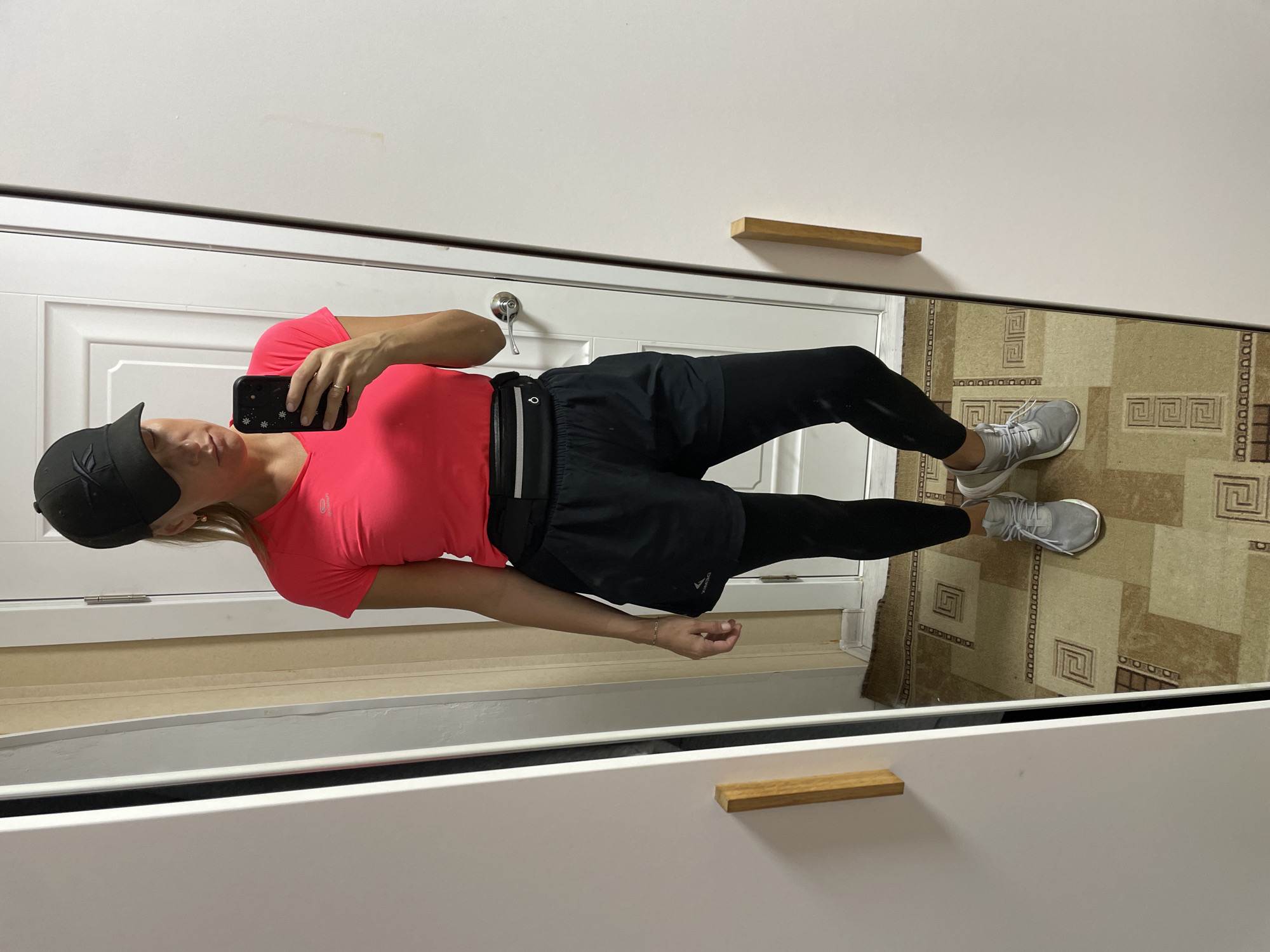 Woman takes mirror selfie in athletic wear in Baranovka