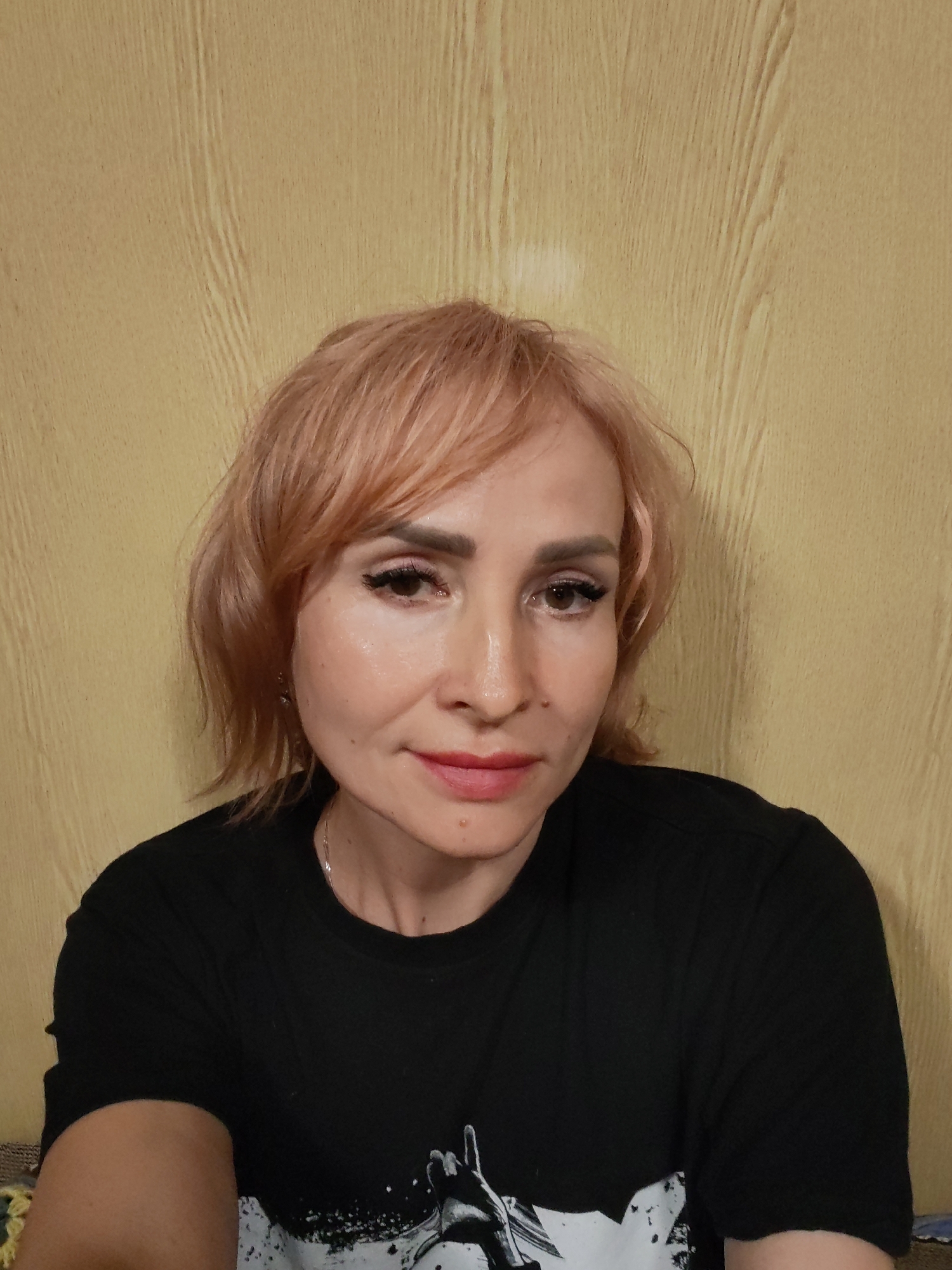 Bold pink hair and graphic tee in a close-up portrait