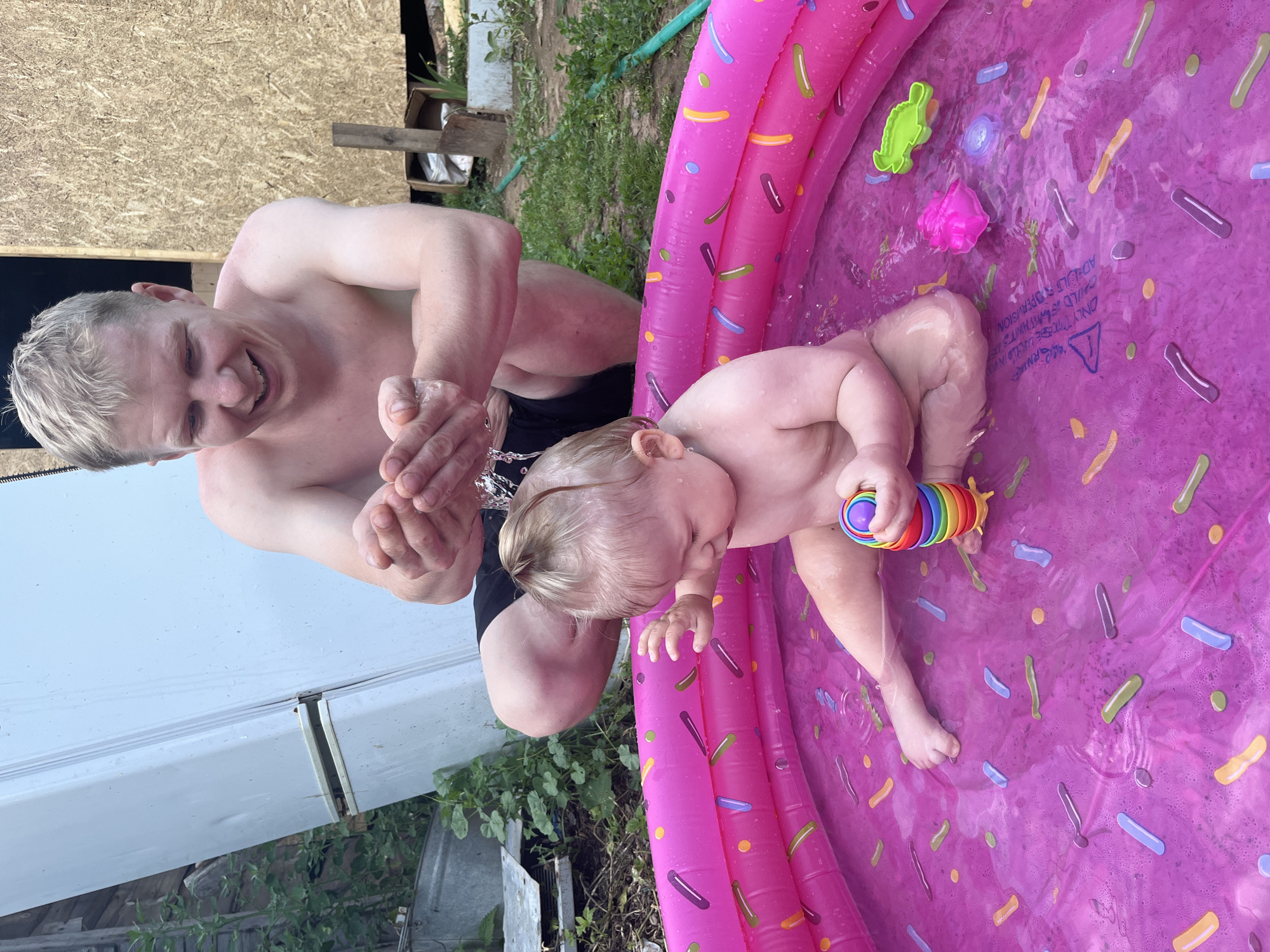 Baby plays in a sprinkle-donut kiddie pool in Fokino