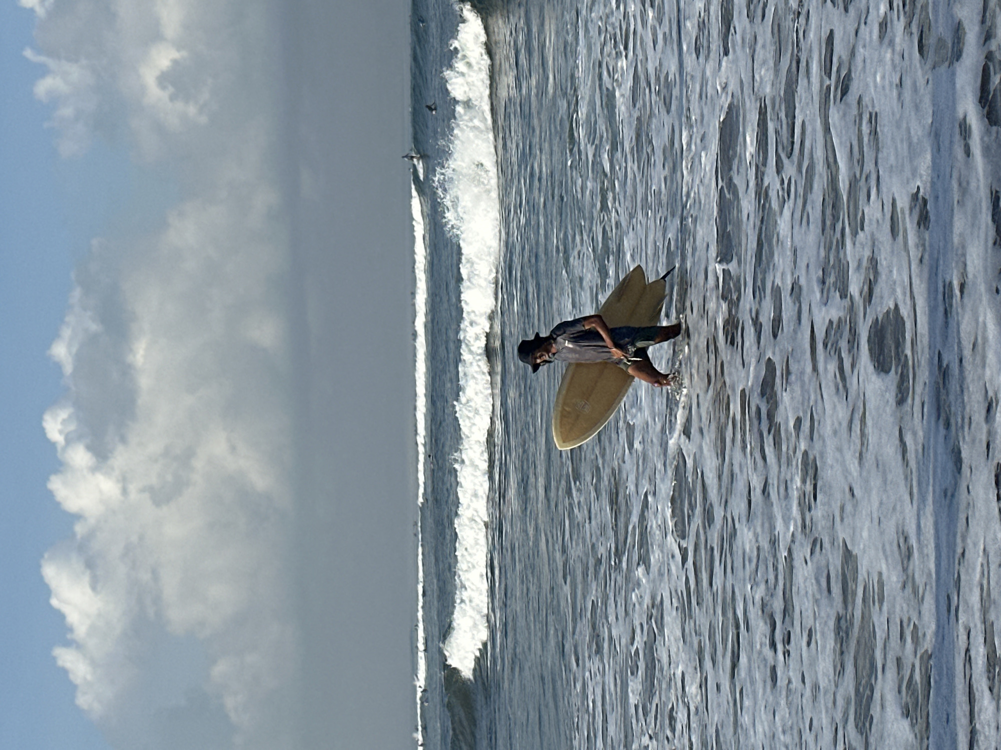 Surfers, beachgoers, and dogs fill North Kuta's shoreline