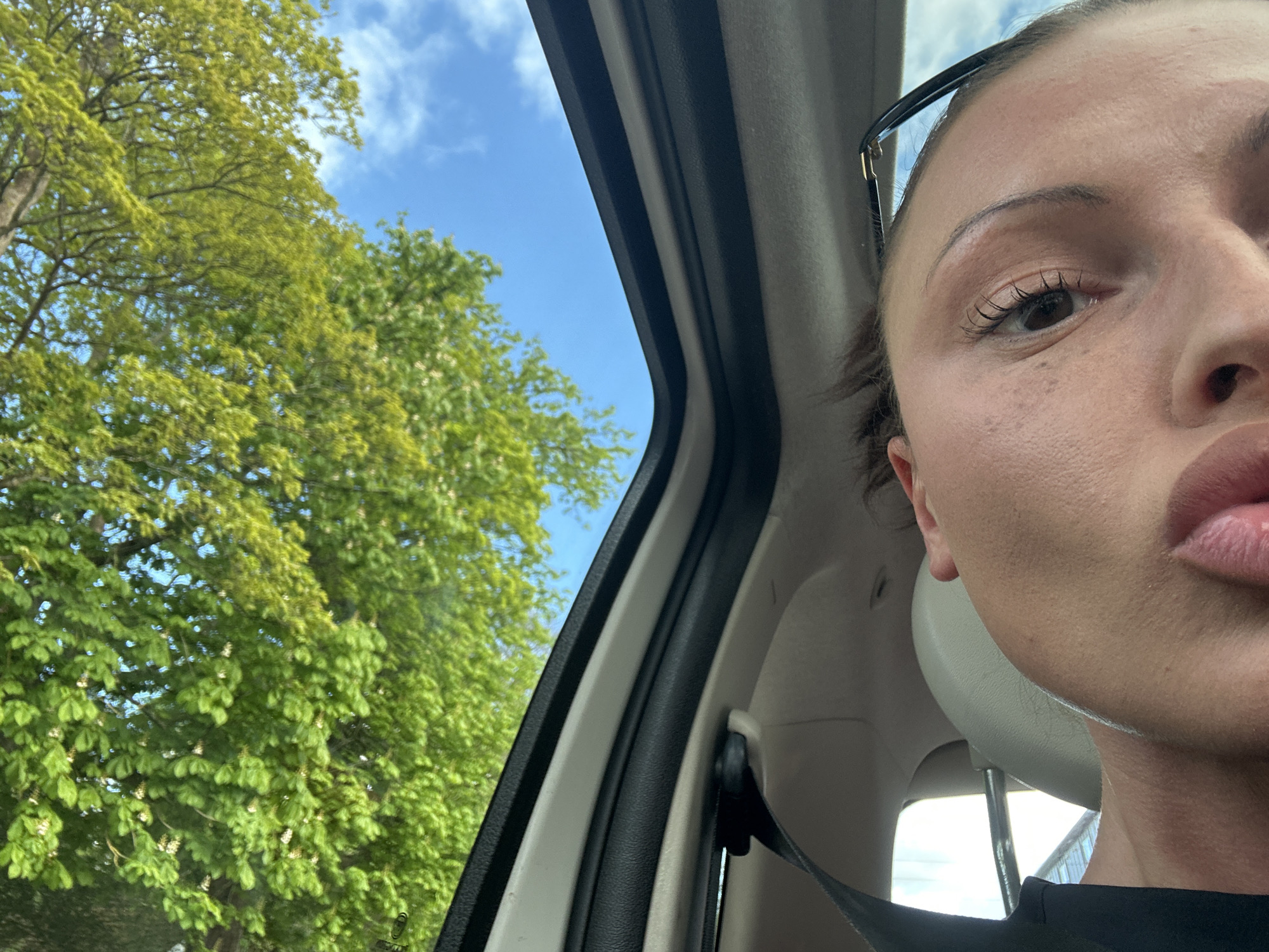 Person captures partial selfie from inside car in Wealden