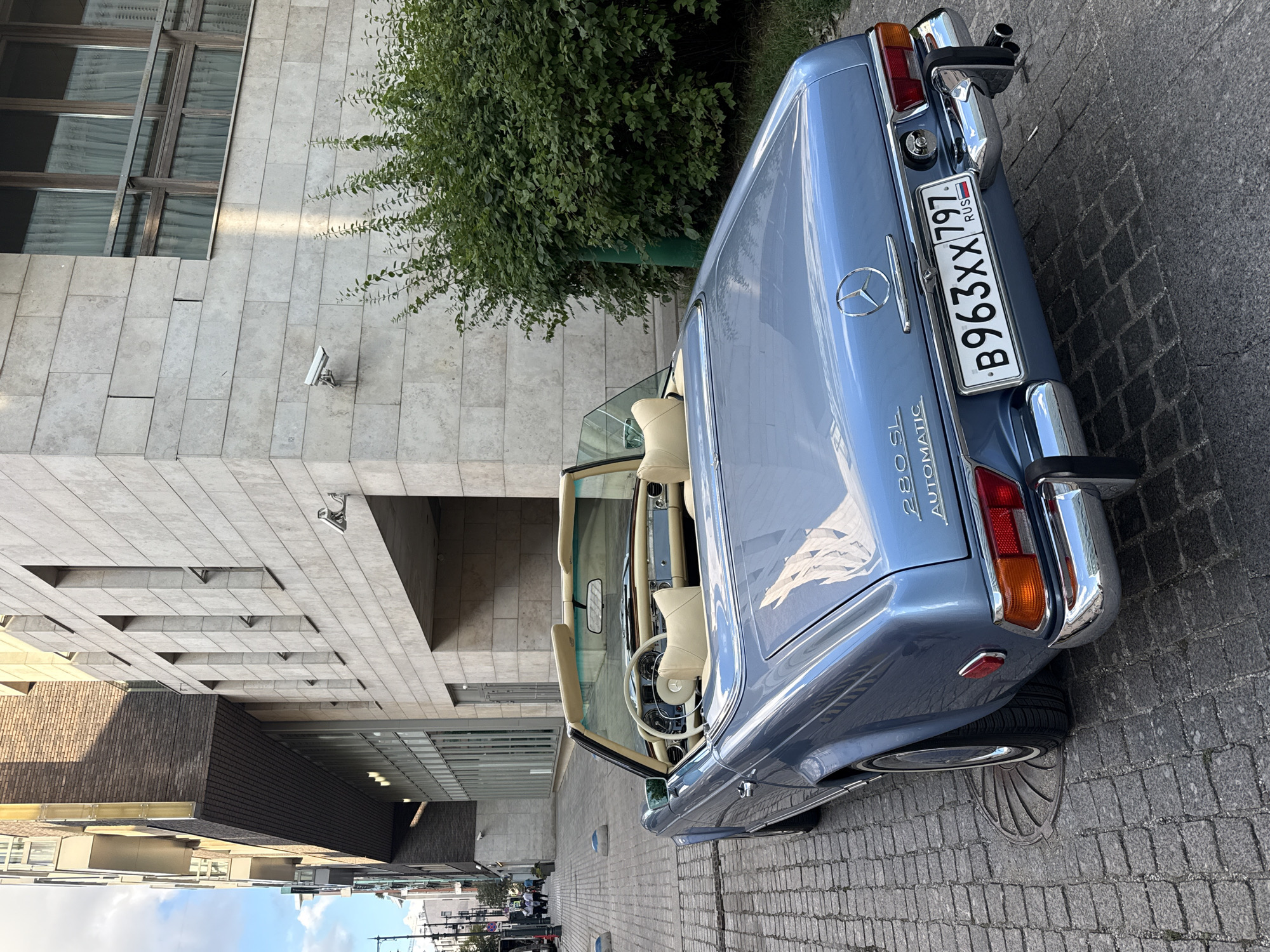 Classic light blue Mercedes-Benz 280 SL on Moscow cobblestones