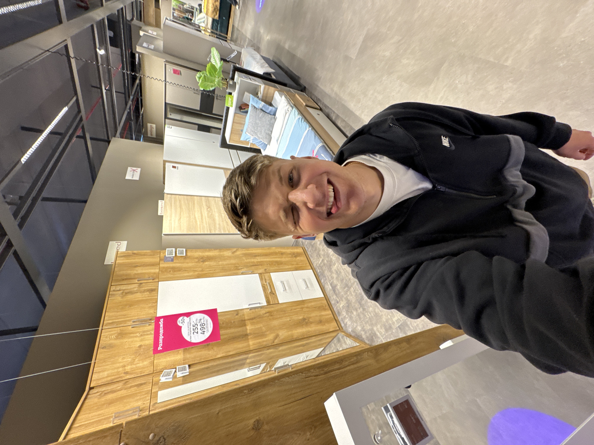 Young man poses playfully in Plovdiv furniture store