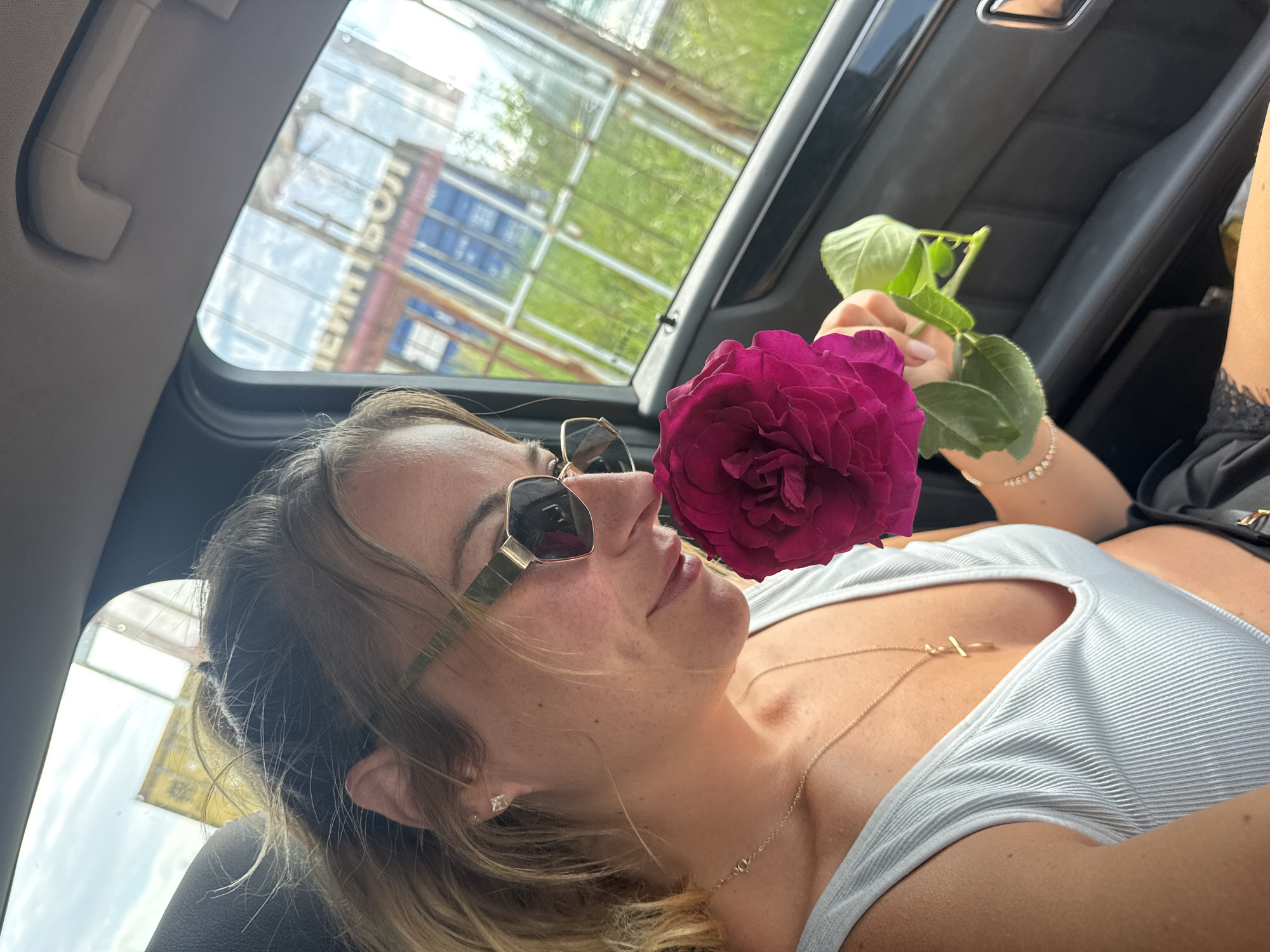 Couple poses with flowers around Mercedes in Bulgaria morning