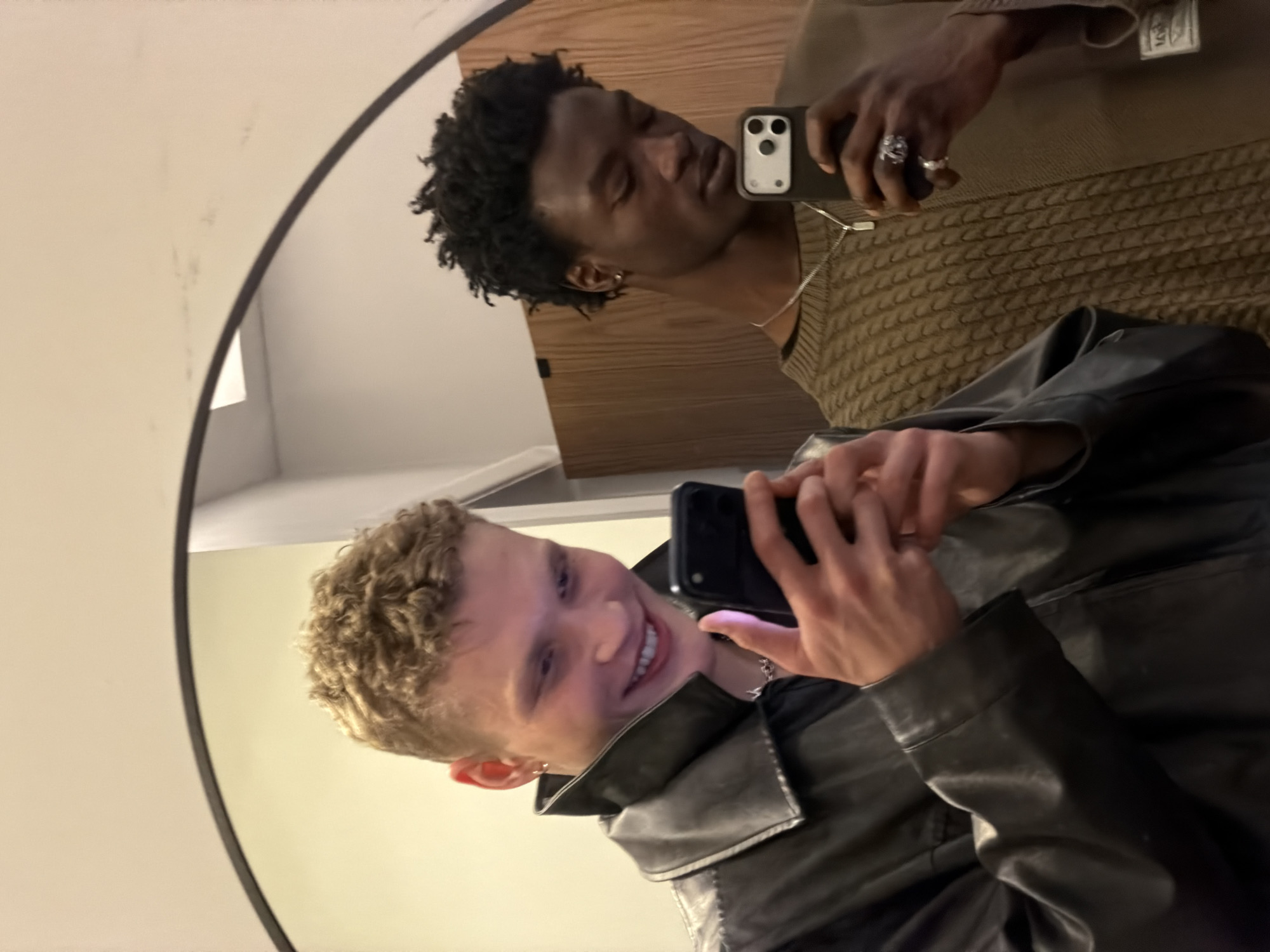 Two young men take mirror selfies in London