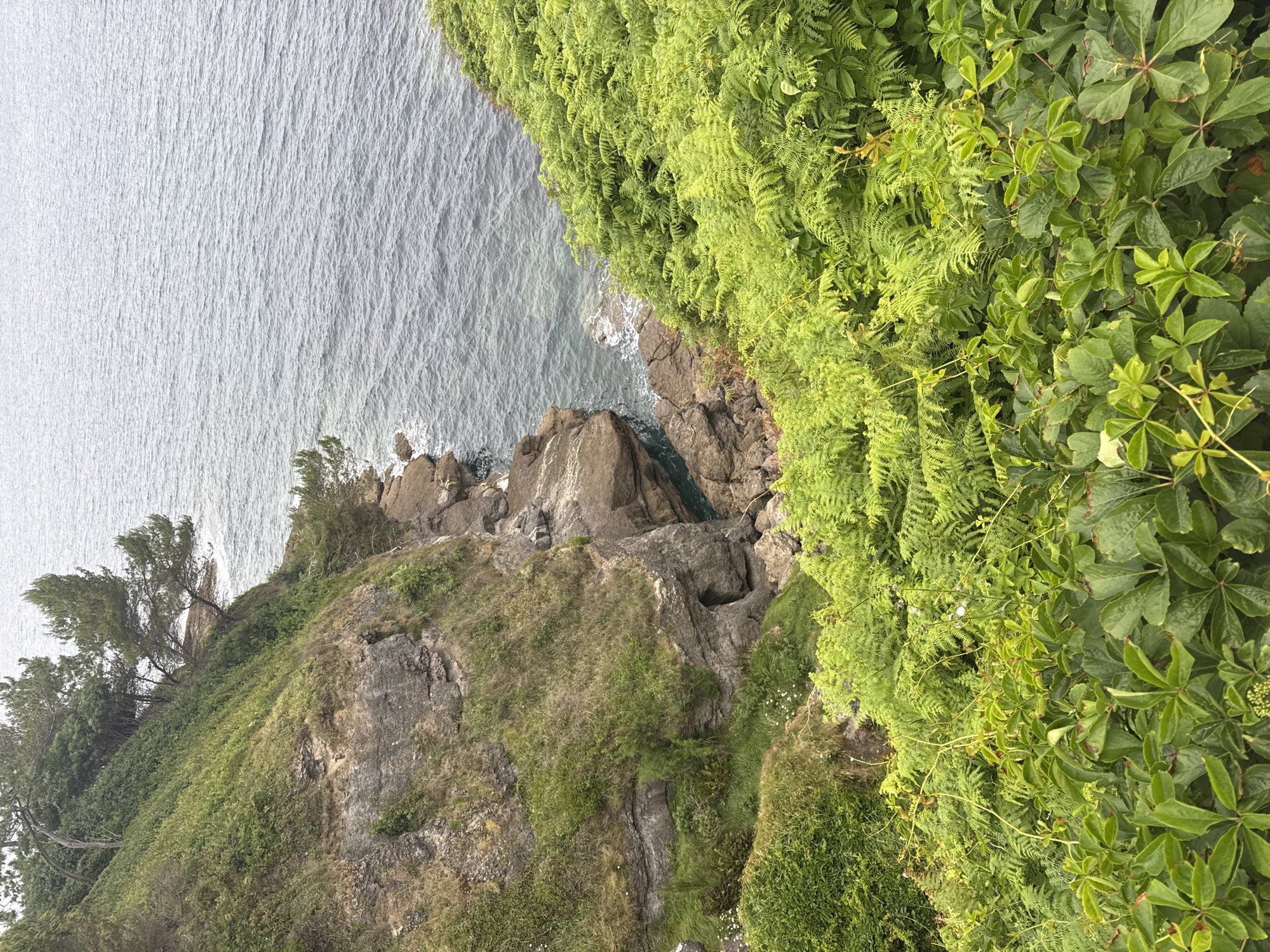 Santander's rocky coastline and Cabo Mayor lighthouse, June afternoon