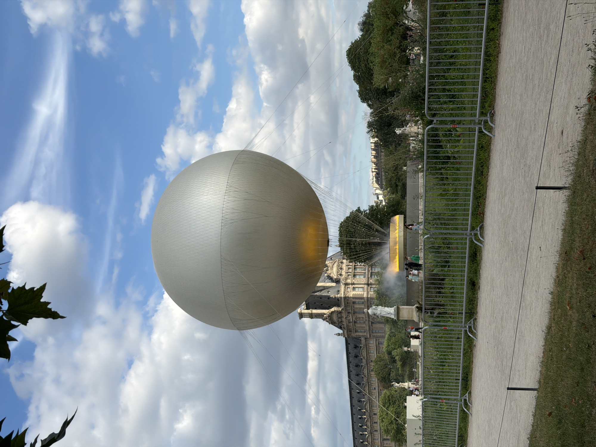 Tethered balloon, fairground rides, and watercolors at a Paris garden event