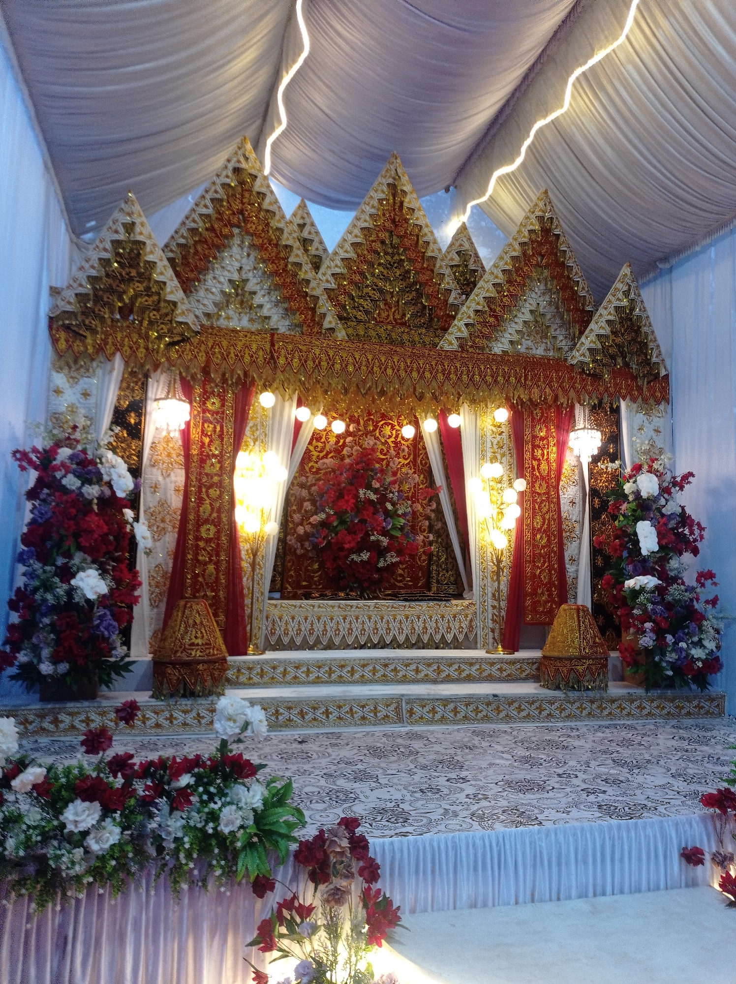 Ornate wedding stage and floral decor in Peudari, Indonesia