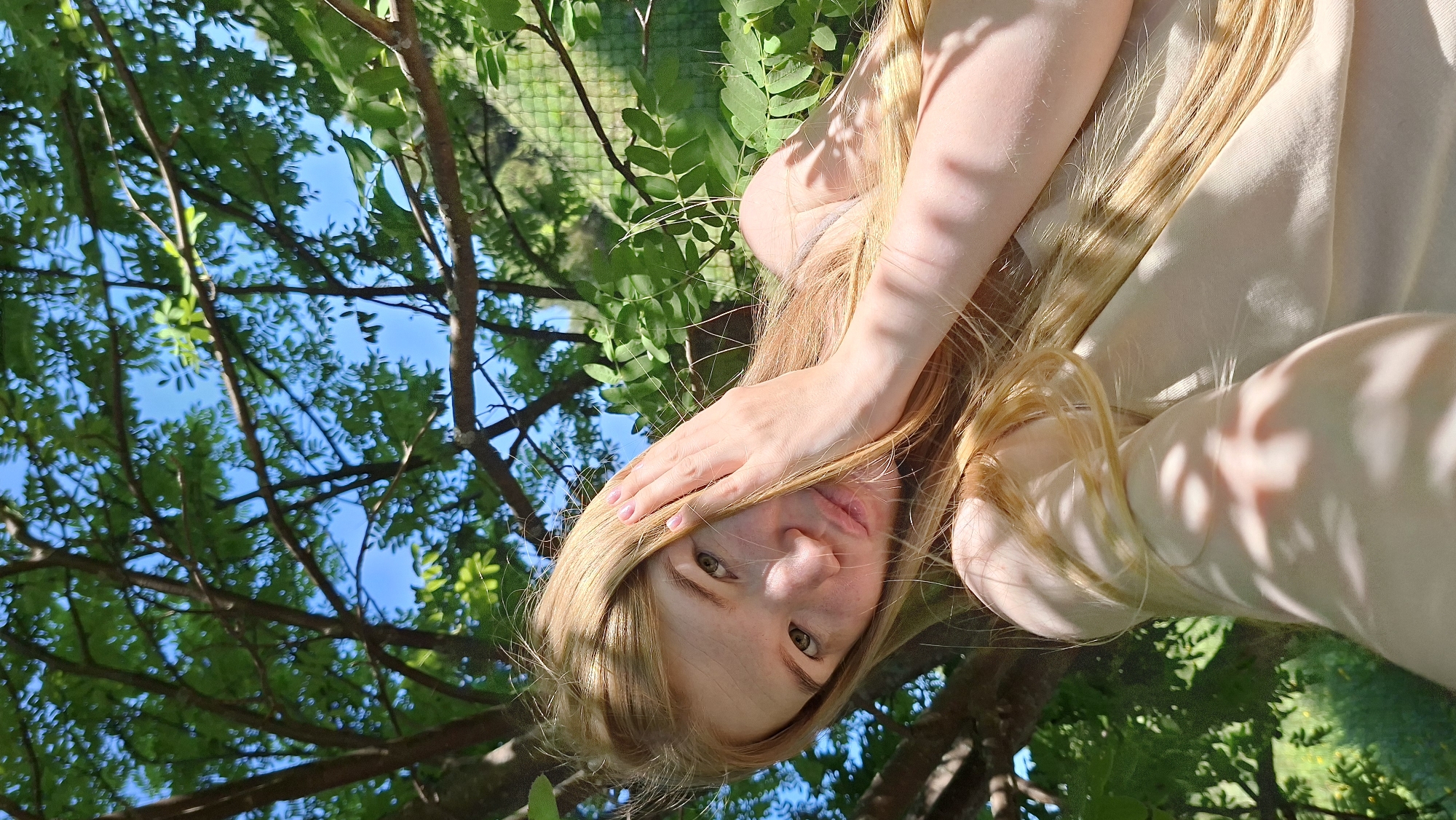 Woman documents spring morning with selfies among blooming trees