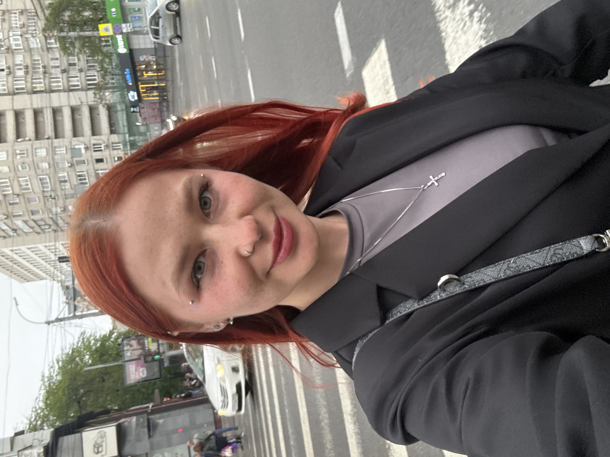 Woman takes selfie on Rostov-on-Don crosswalk, boy nearby