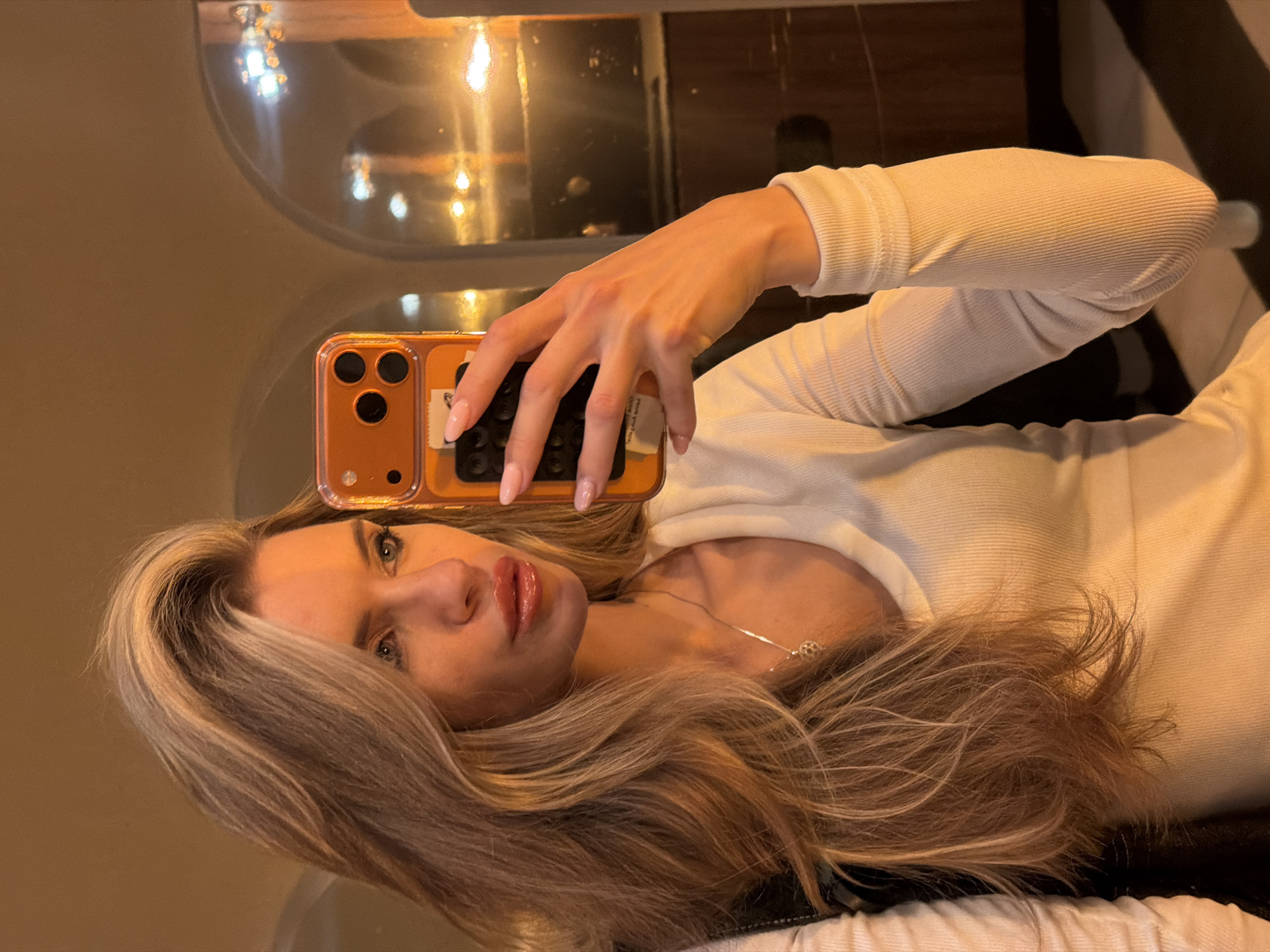 Woman takes mirror selfies in Berlin bathroom