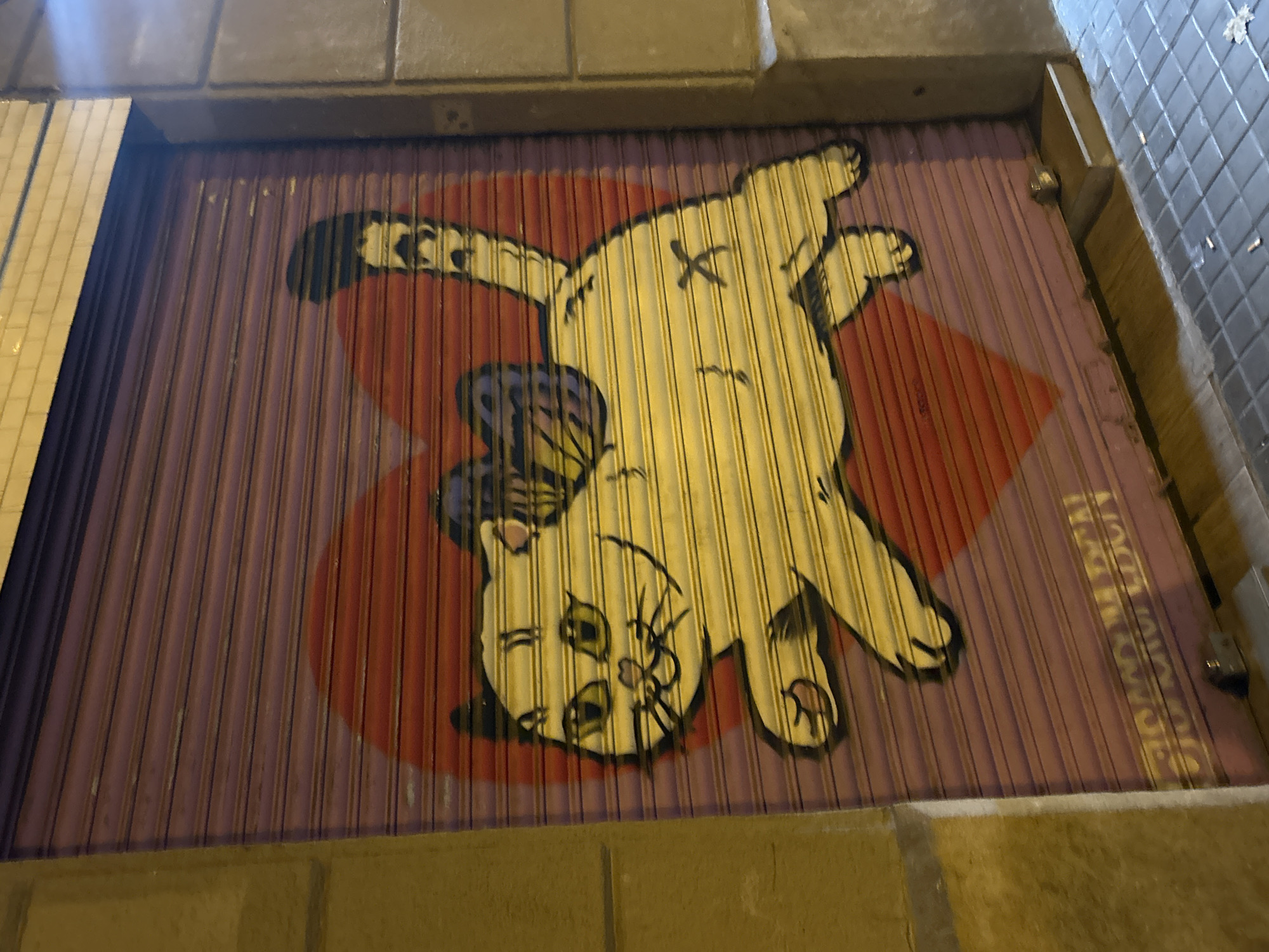 Sant Antoni neighborhood at night, murals and wet sidewalks