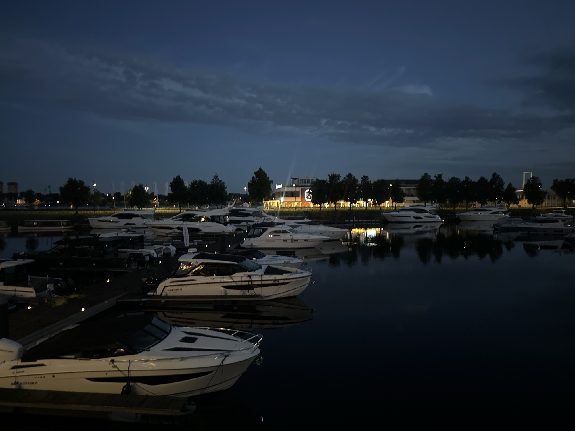 Riga marina at dusk, nightlife starting nearby