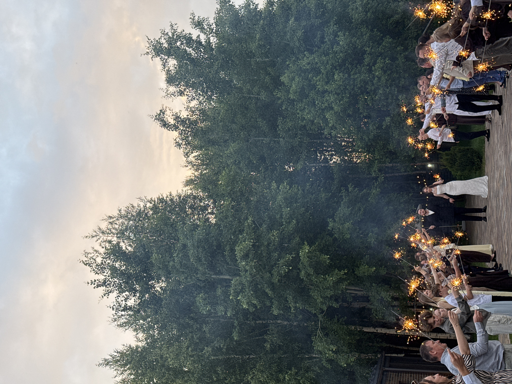 Wedding couple walks hand-in-hand during twilight ceremony in Perm