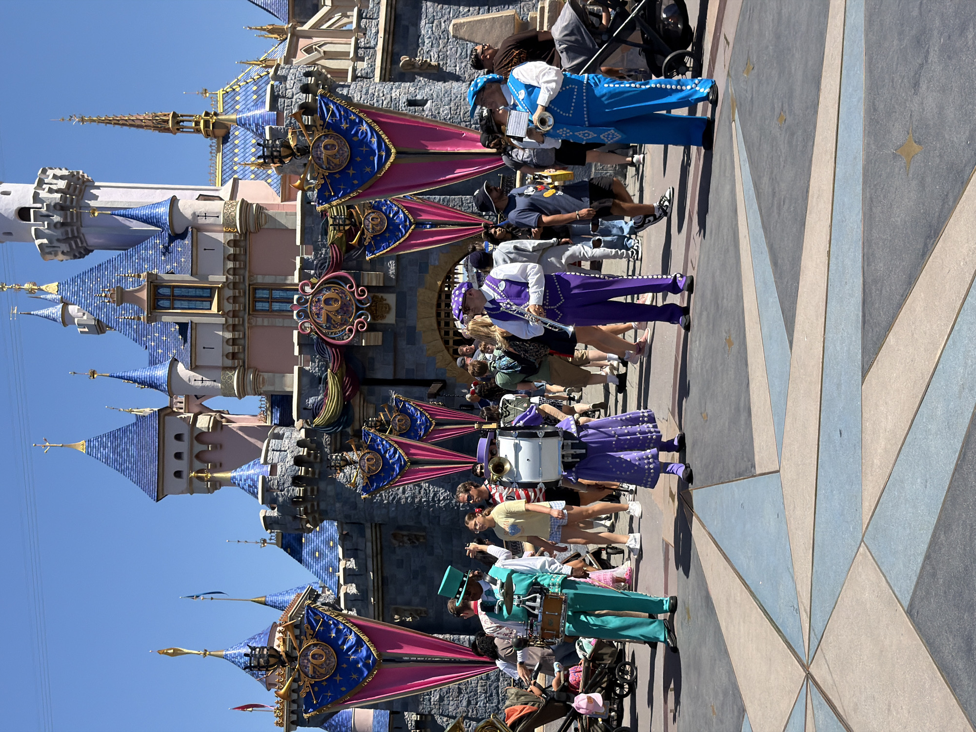 Marching band performs at Disneyland's Sleeping Beauty Castle plaza