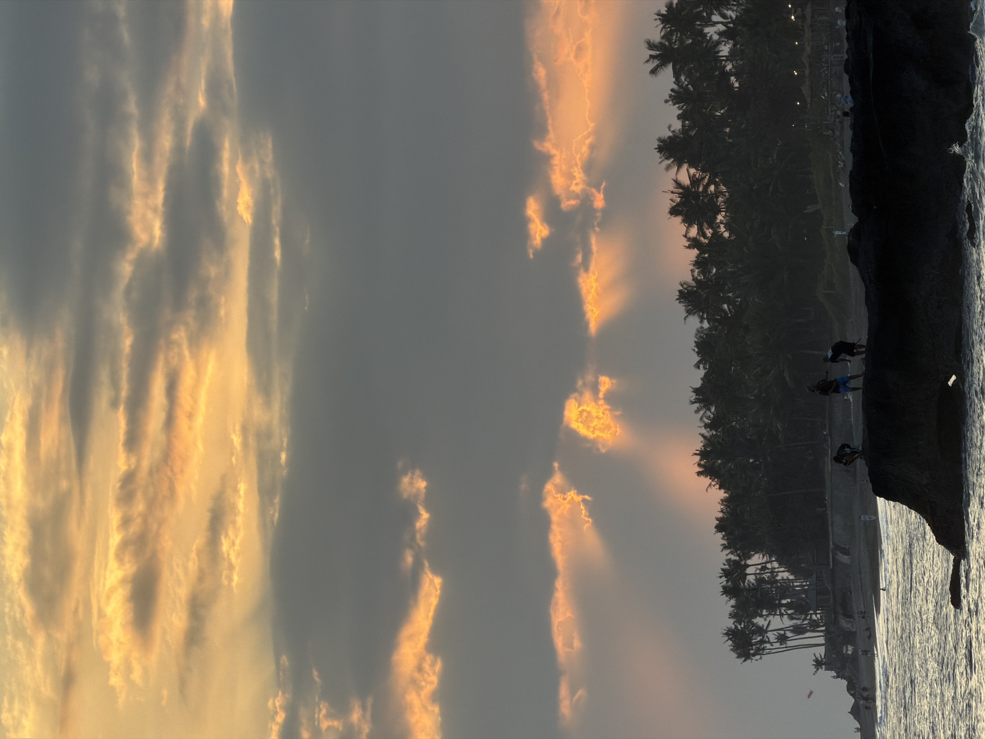 Sunset gathering on Mengwi's grassy oceanside with beach play