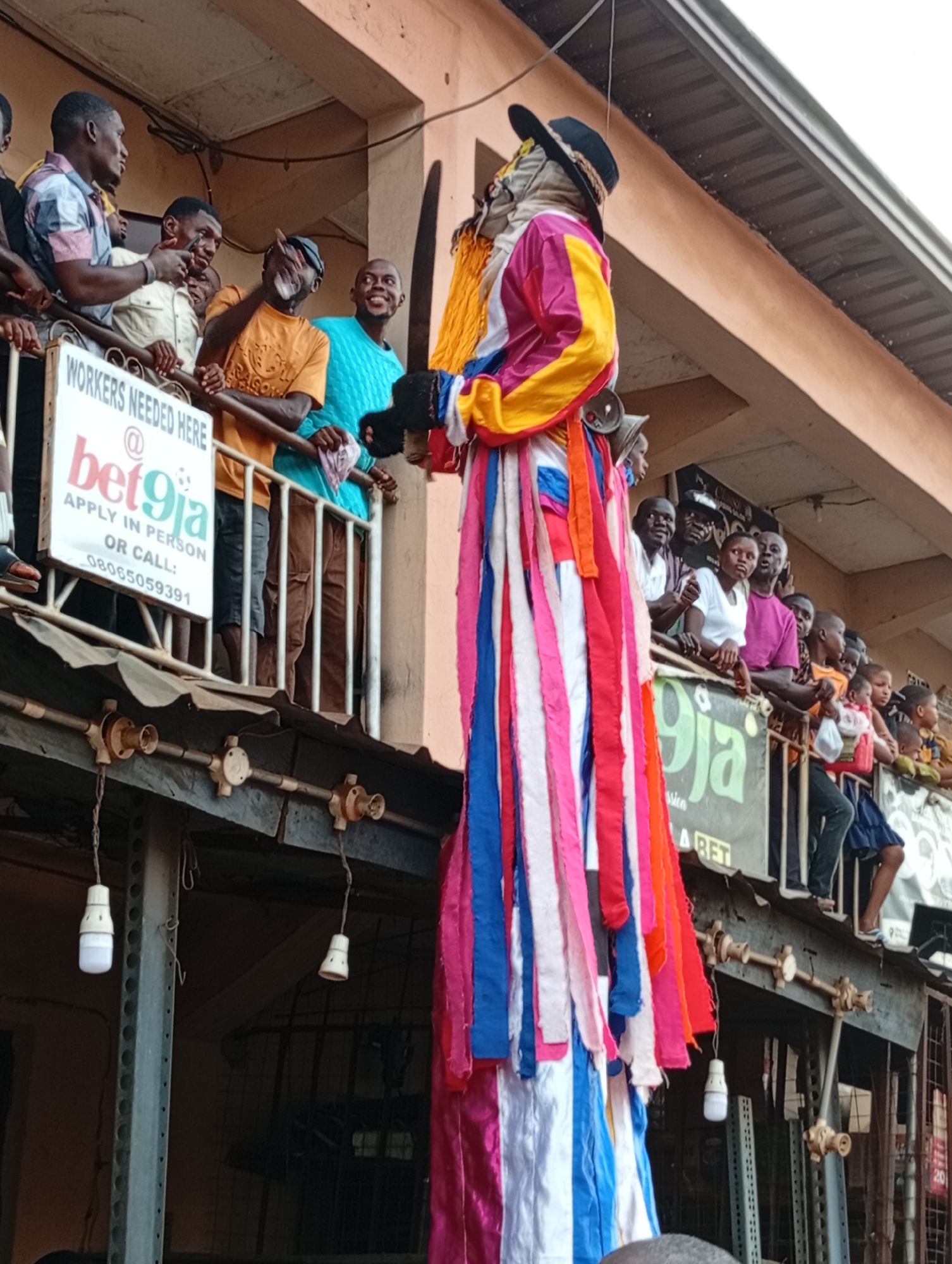 Costumed figure draws crowd in urban gathering