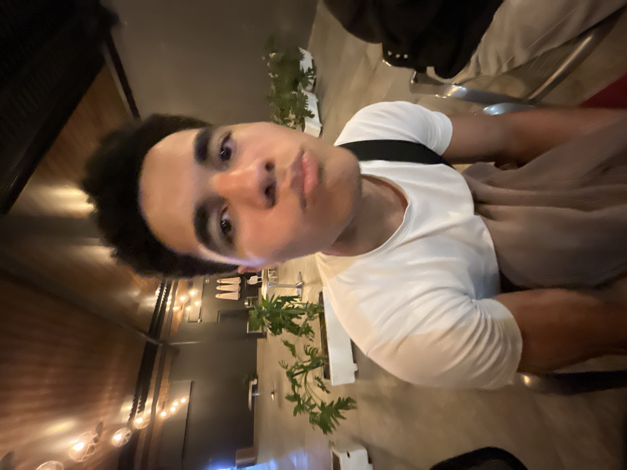 Young man takes selfie in Mexican restaurant early morning