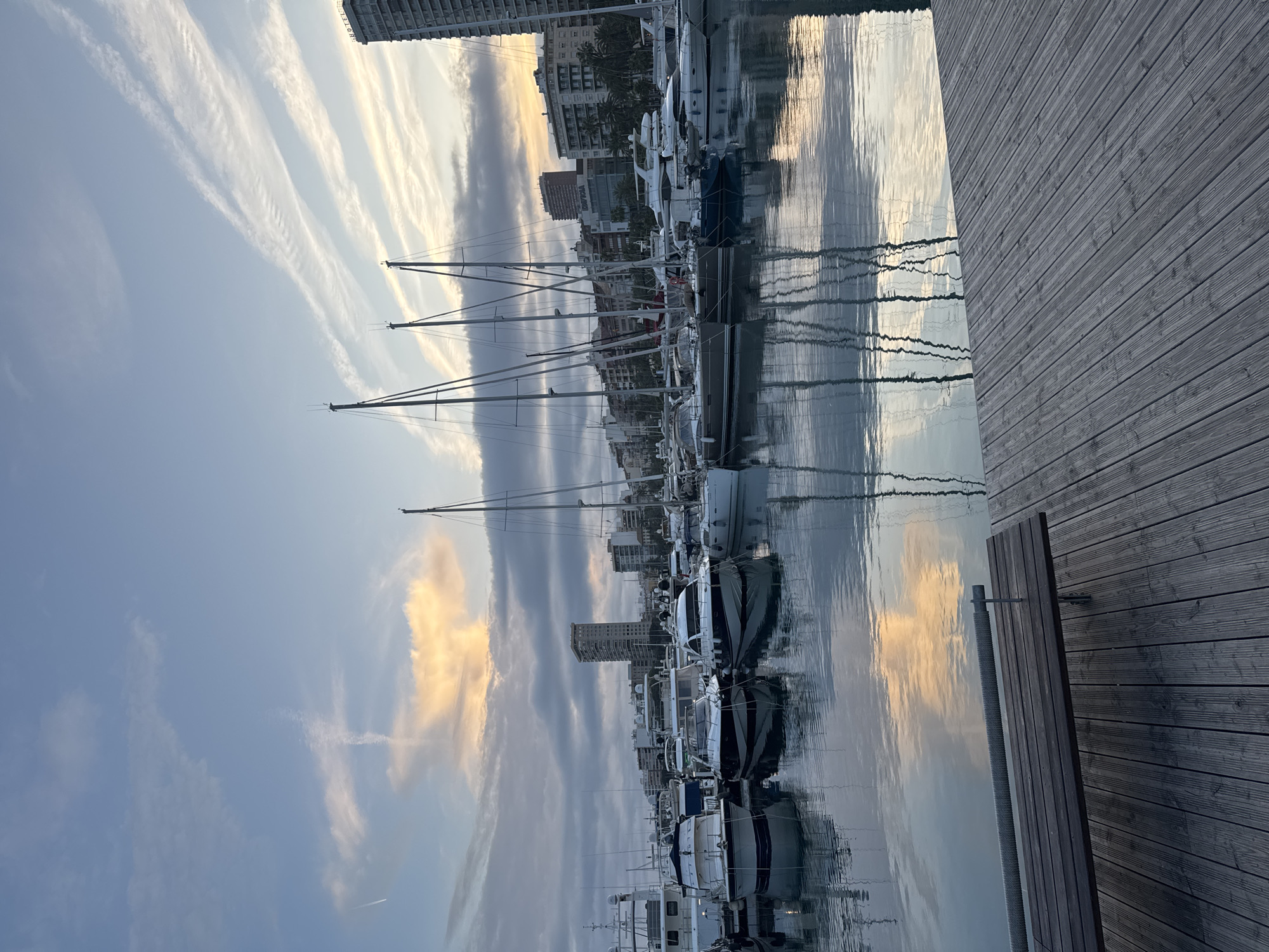 Evening marina scene captured in Alicante with contrails overhead