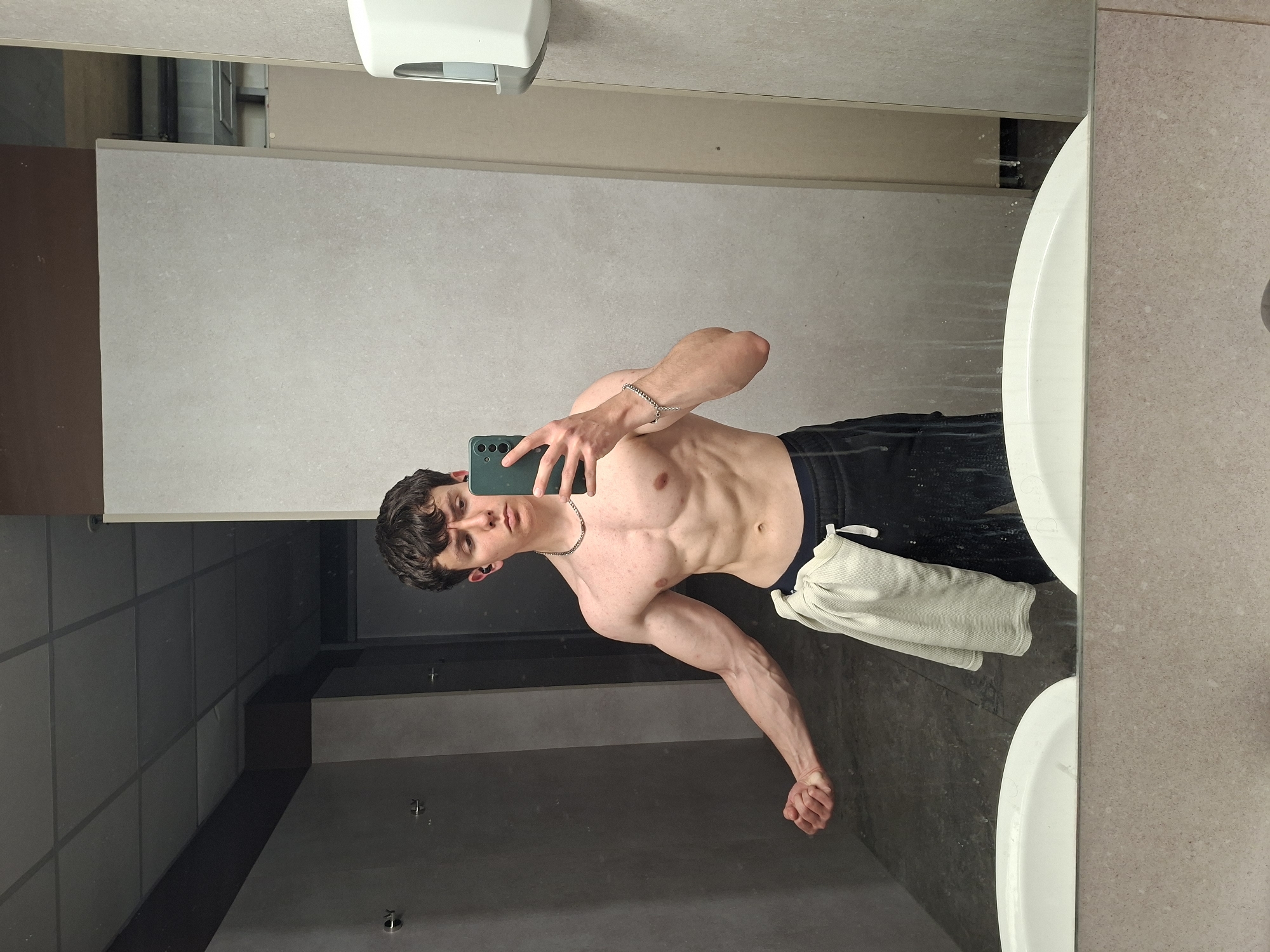 Young man takes mirror selfies in Plovdiv public restroom