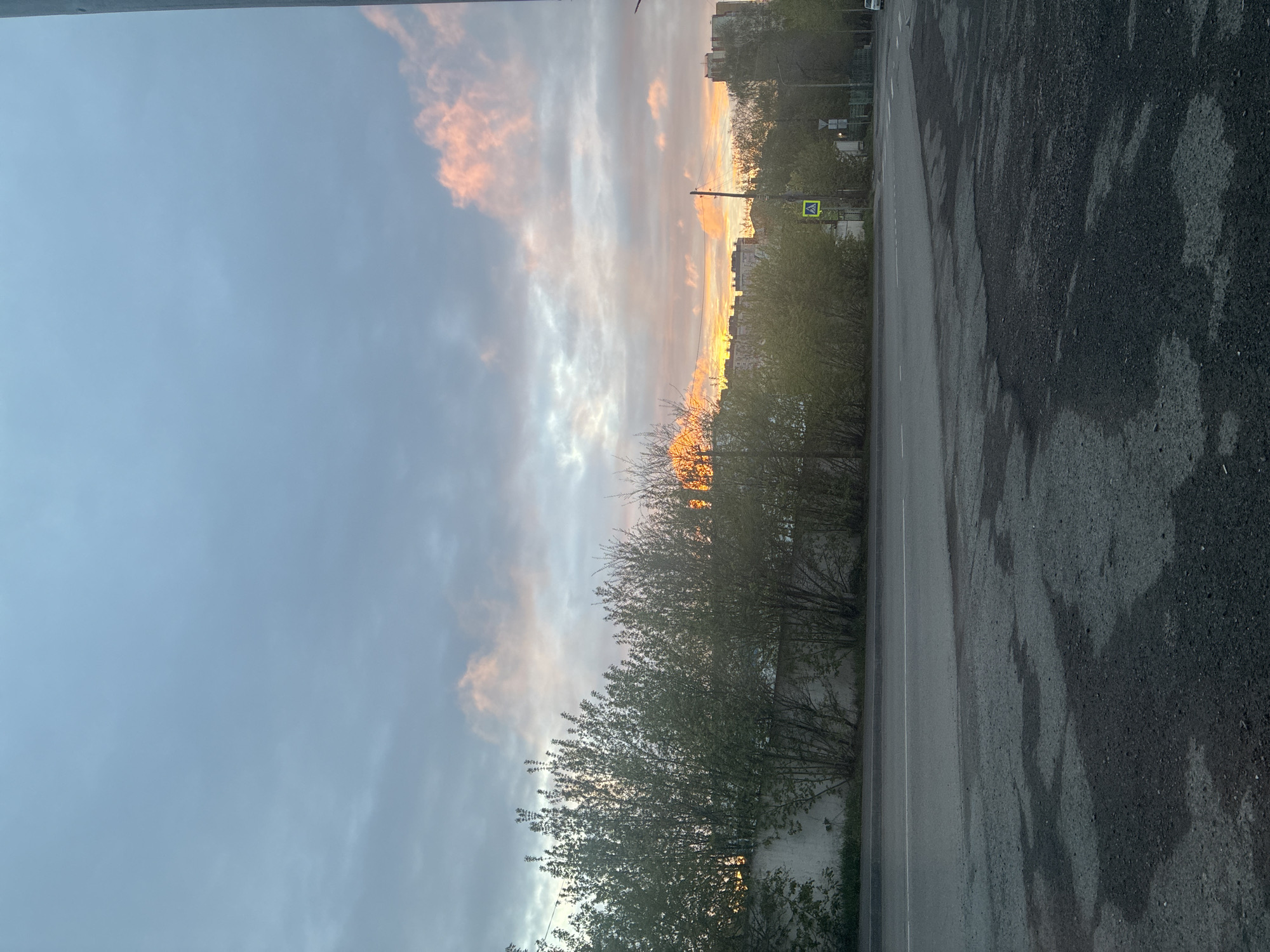 Urban sunset documented across city streets during evening hours