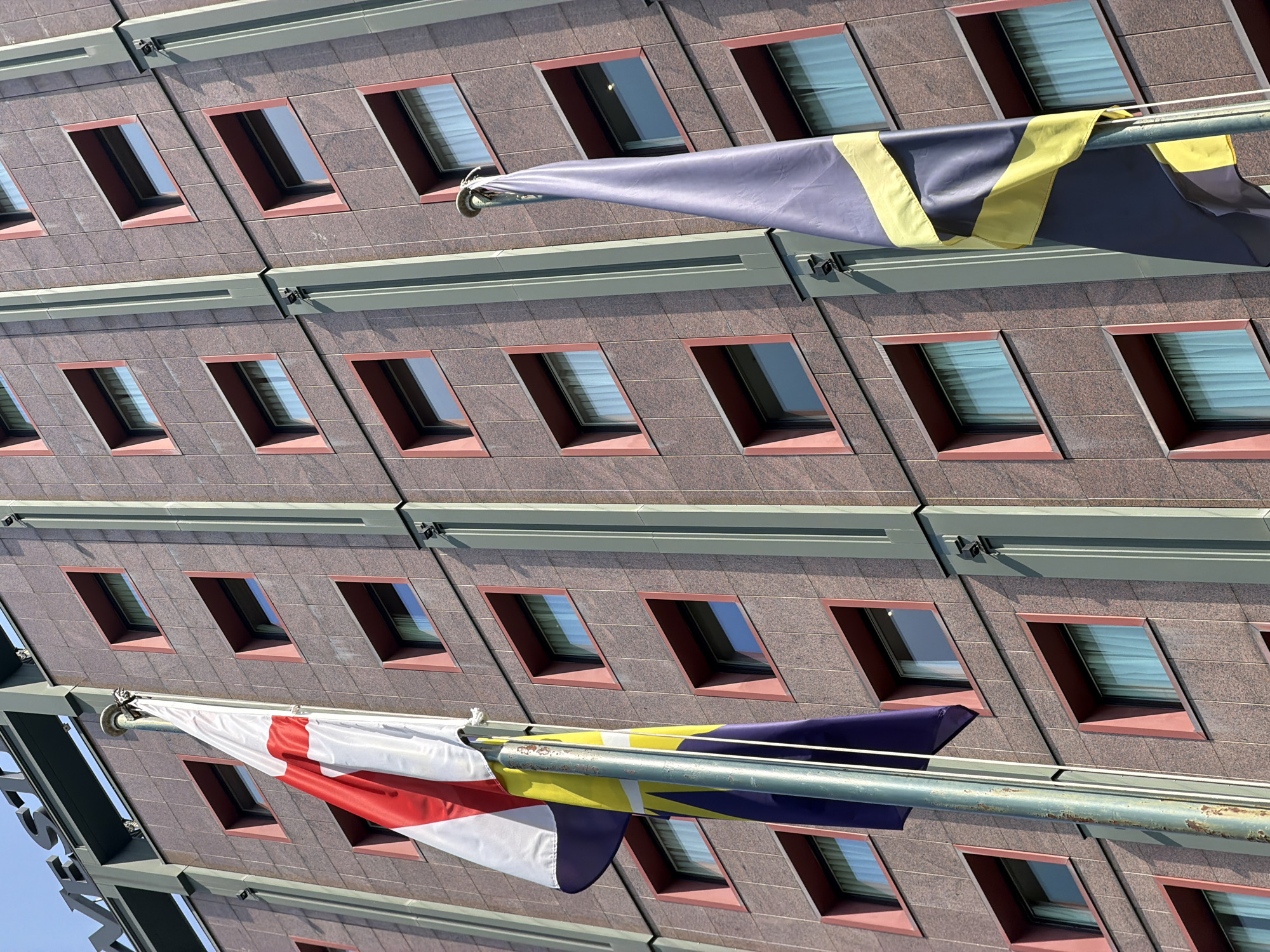 Street life and architecture across central Milan on a July afternoon