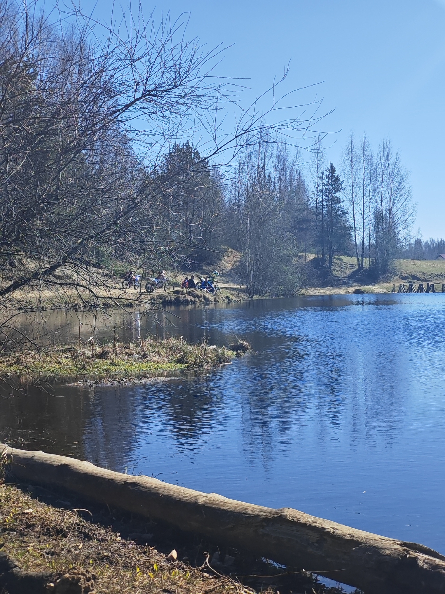 Person sits on makeshift bench by lake in Tokkari-Lend