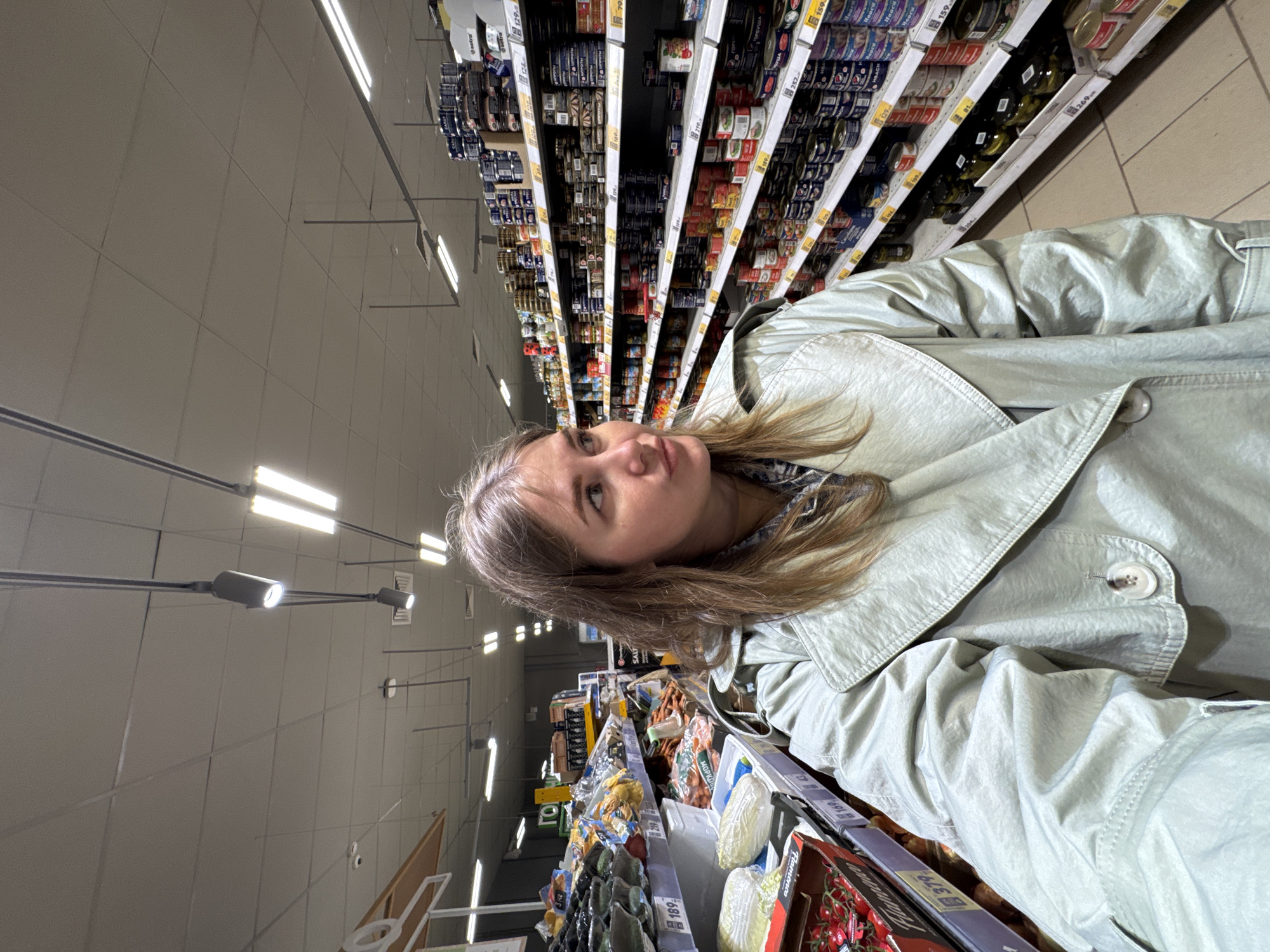 Couple shops and takes photos at grocery store in Горный