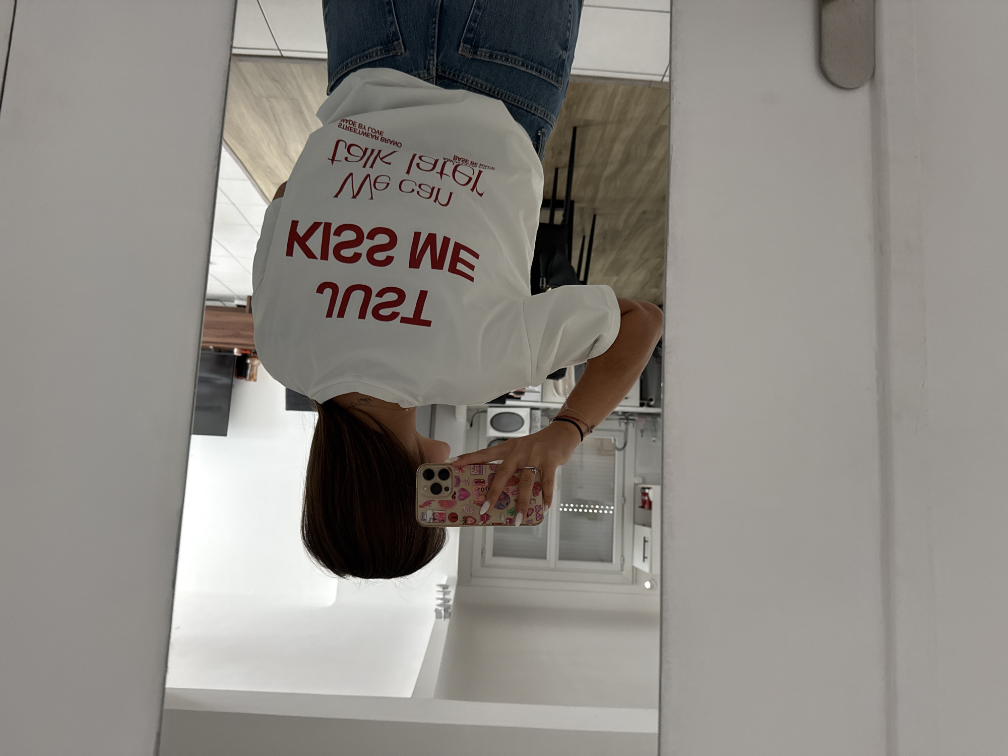 Woman takes selfies in tour merchandise shirt in Cannes