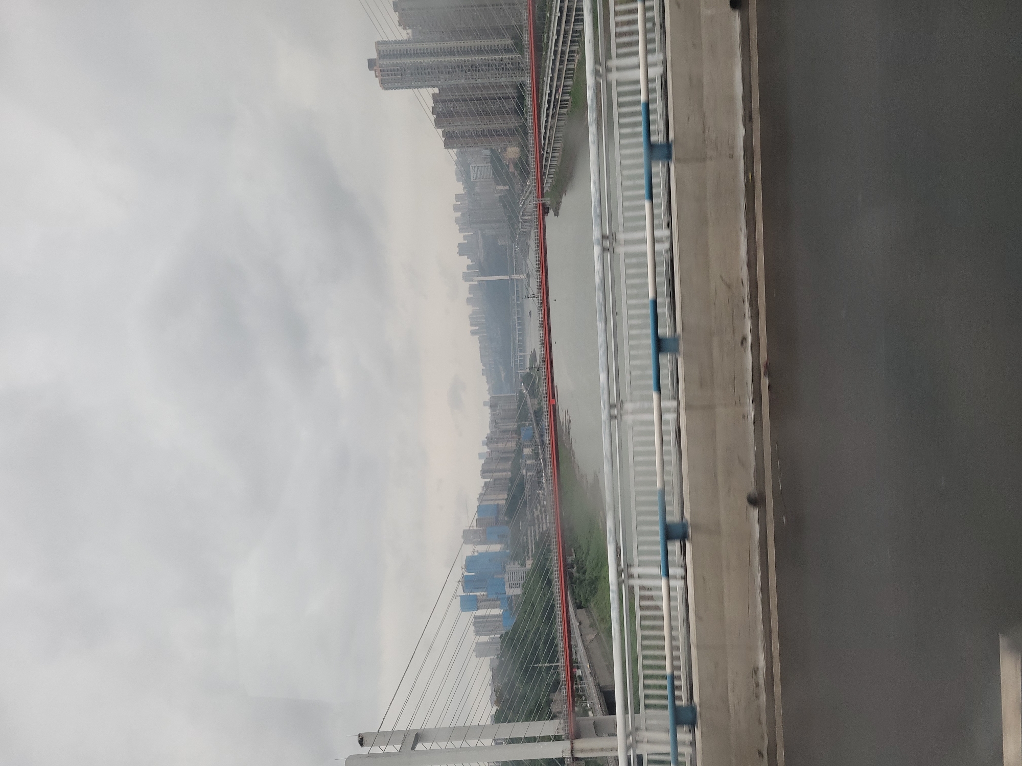 Bridge views capture foggy Chongqing cityscape, unusual parked car