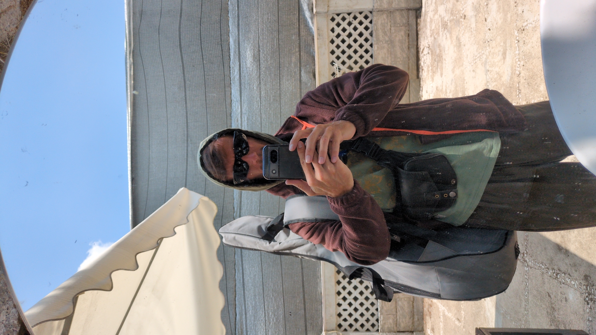 Hooded photographer with guitar case spotted in Da Lat