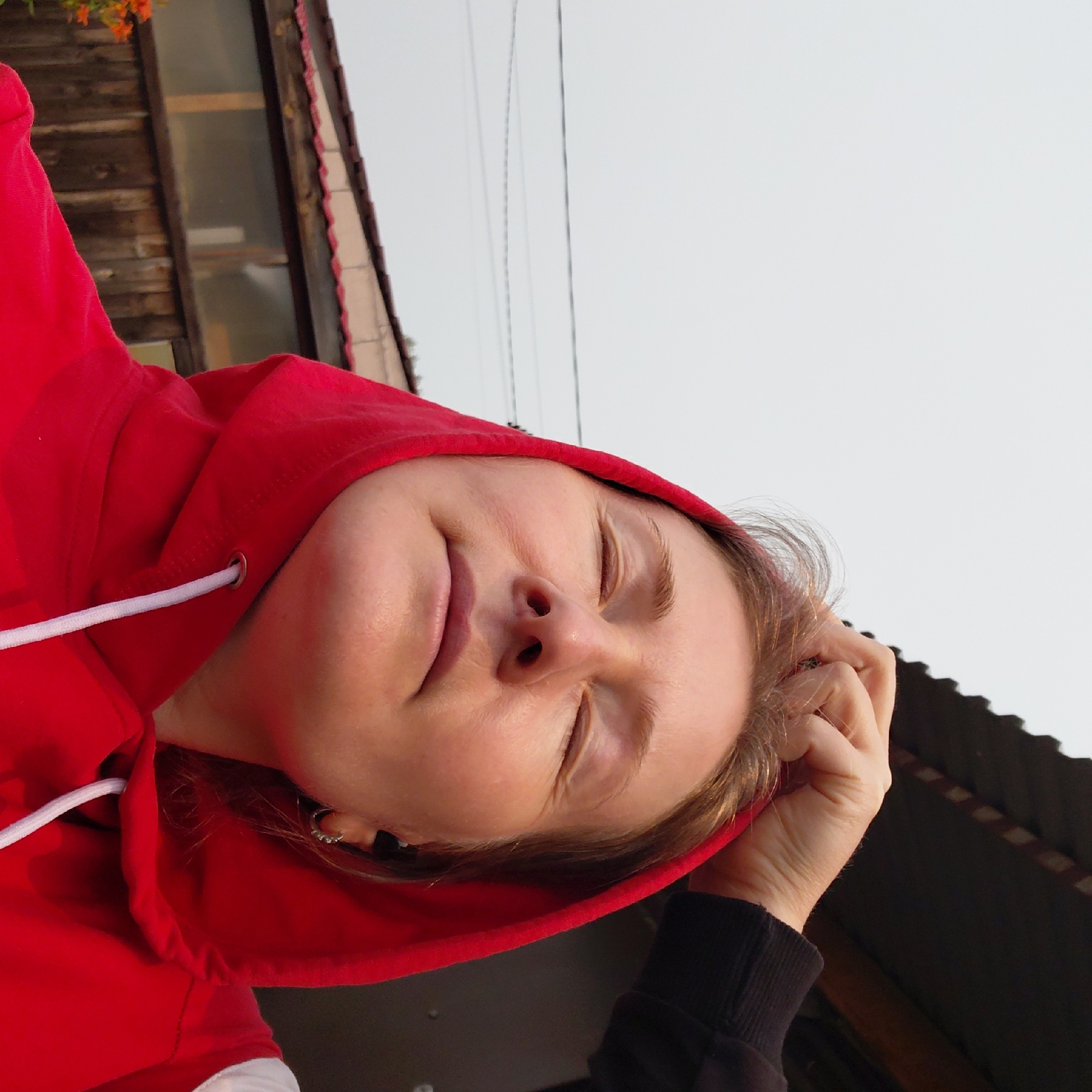 Playful multi-angle self-portrait session in a red hoodie