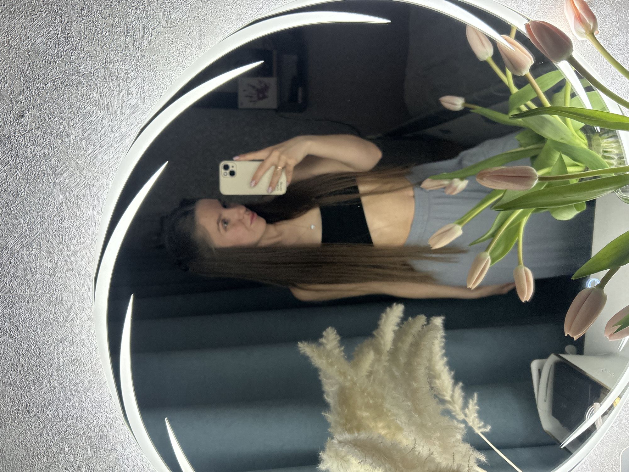 Woman takes tulip selfies in ring light mirror, Klin