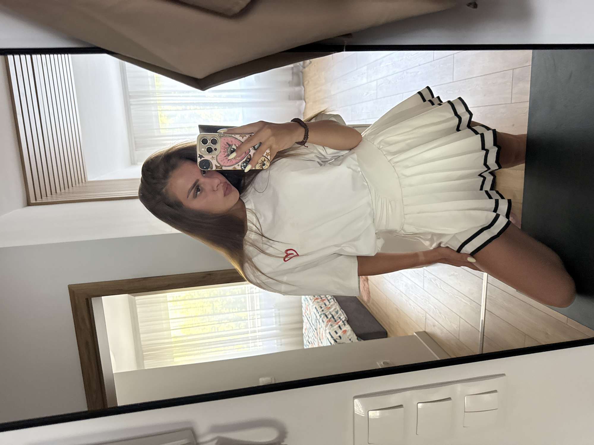 Mirror selfie session in a Plovdiv bedroom, white outfit