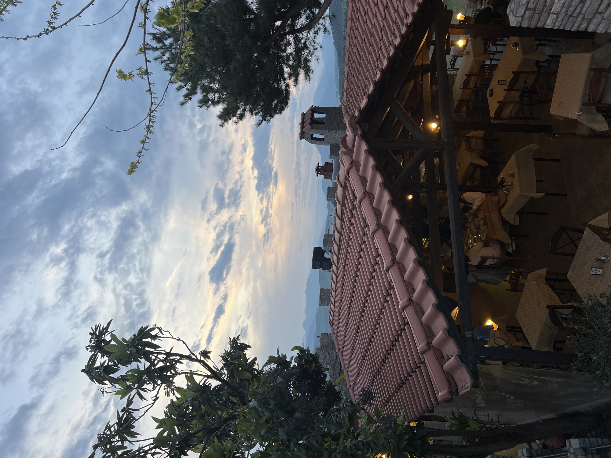 Restaurant dining area prepares for evening service in Kastraki