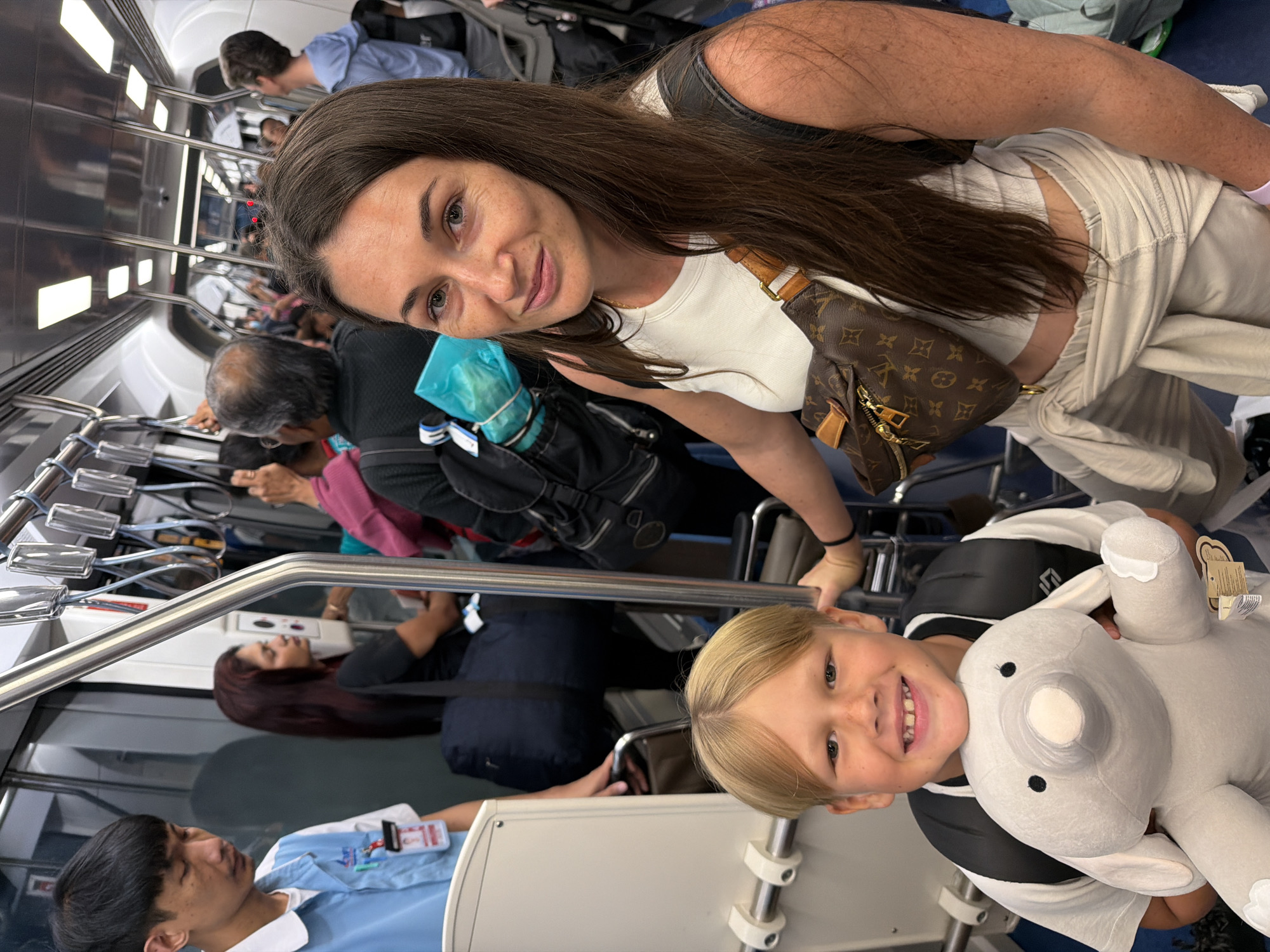 Crowded train ride through Nong Prue with luggage and drinks in hand