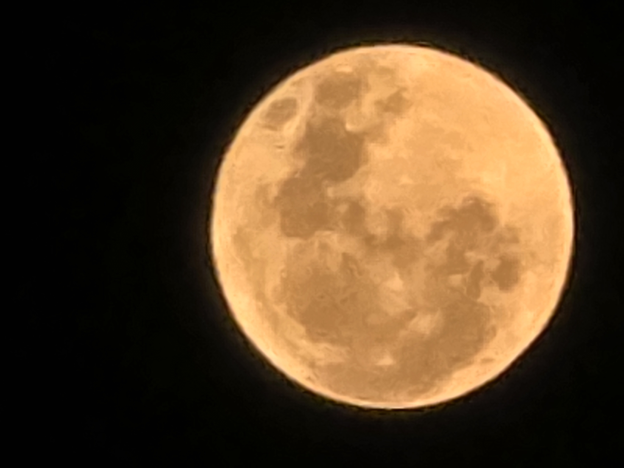 Full moon rises warm and golden over Sofia