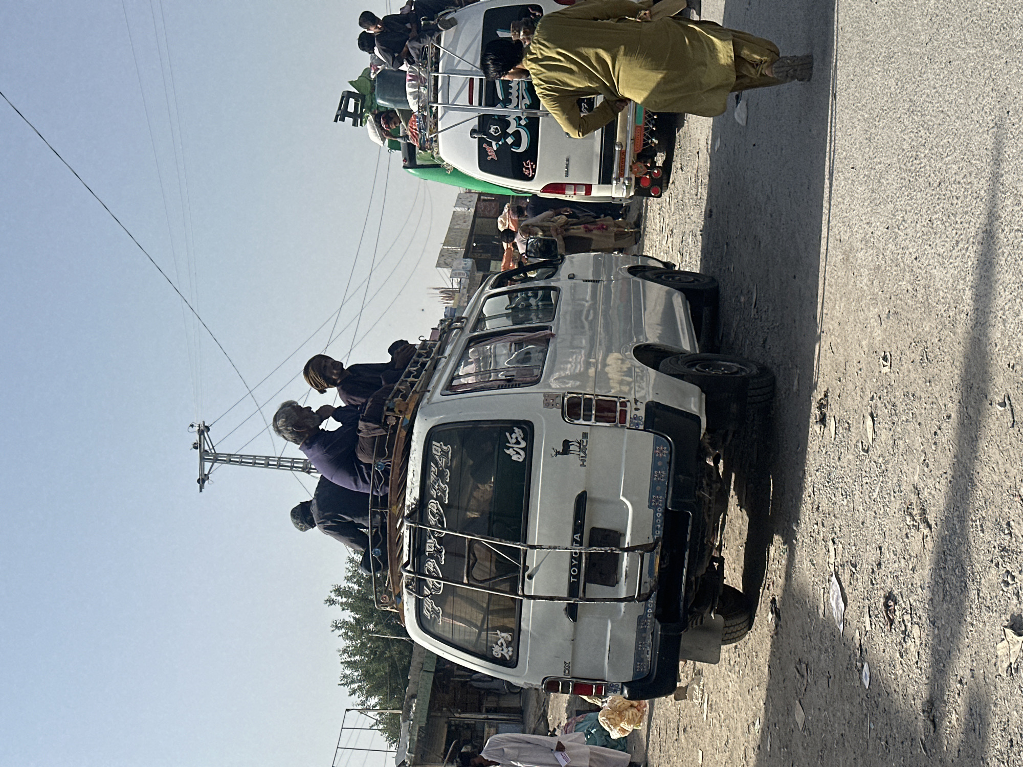 Overloaded vans spotted on Quetta street during sunny day