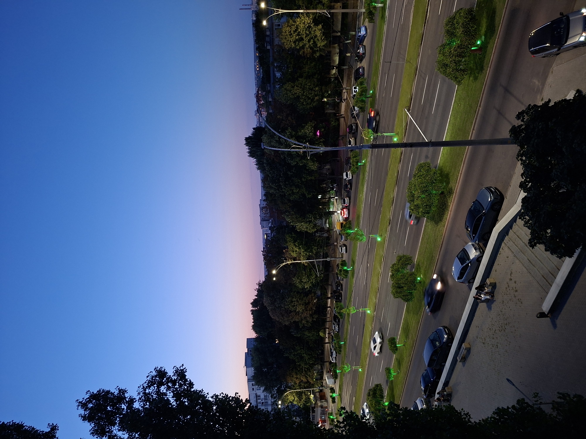 Chișinău at dusk: lit boulevards and busy summer market stalls