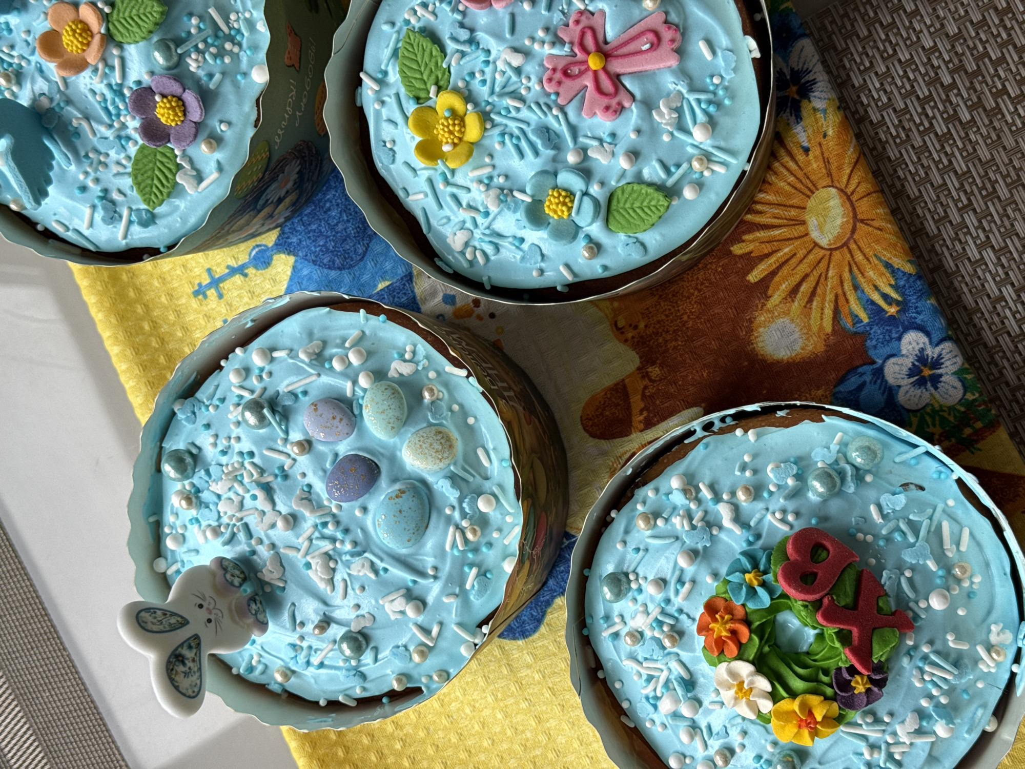 Blue-frosted Easter cakes displayed on decorated tables in Kyiv