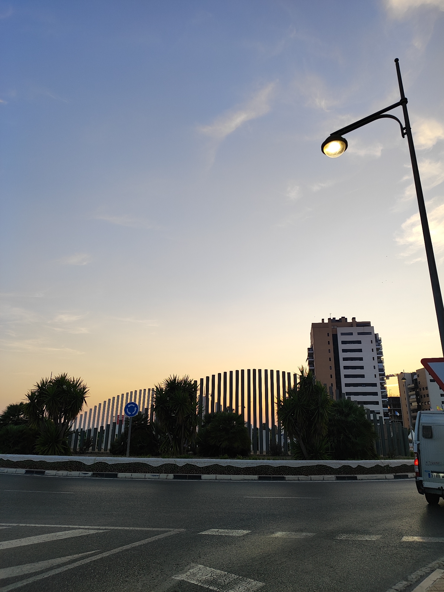 Street lamp glows at dusk in El Campello, Spain